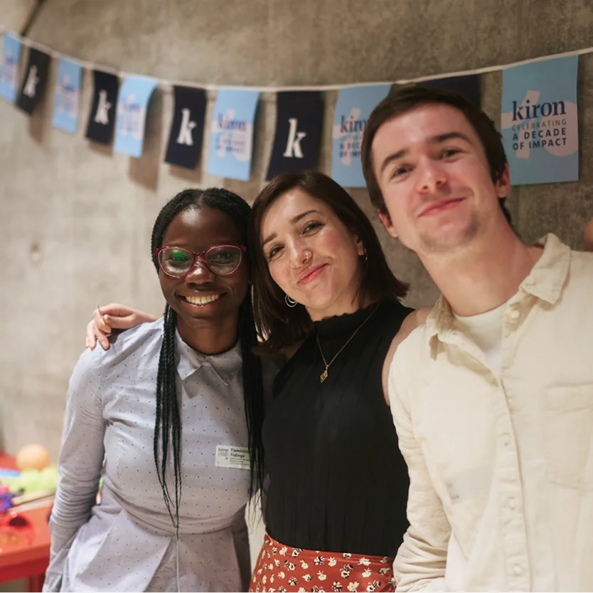 Three NextGen Leaders posing for the camera, hugging and smiling