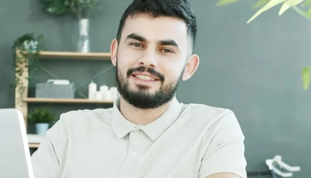 A friendly looking bearded person