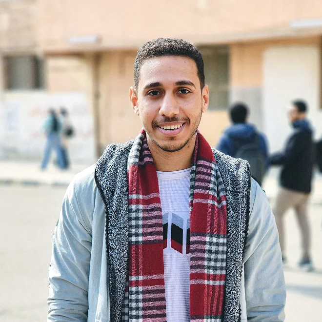 A young Arabic looking man smiling into the camera