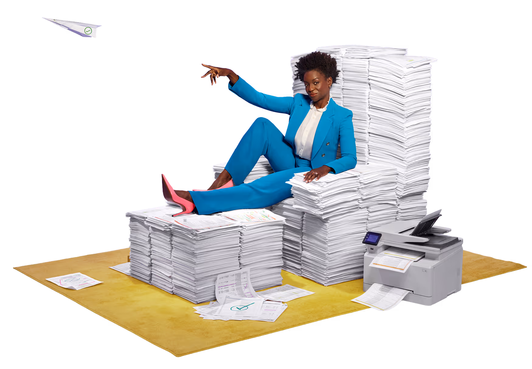 Woman in a blue suit and pink heels sitting confidently on a throne made of stacked papers next to a printing machine.