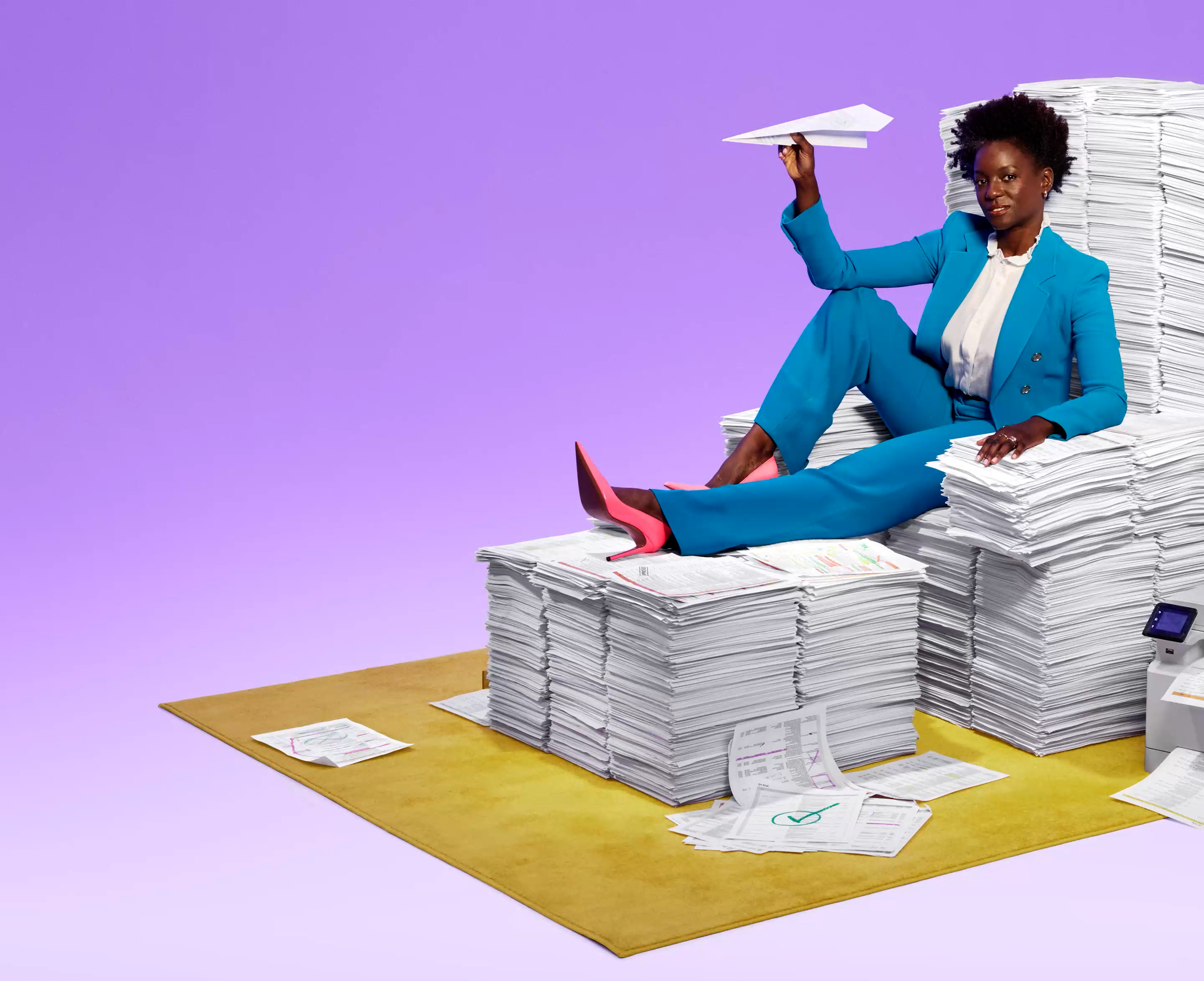 woman sitting on a paper throne throwing a paper airplane