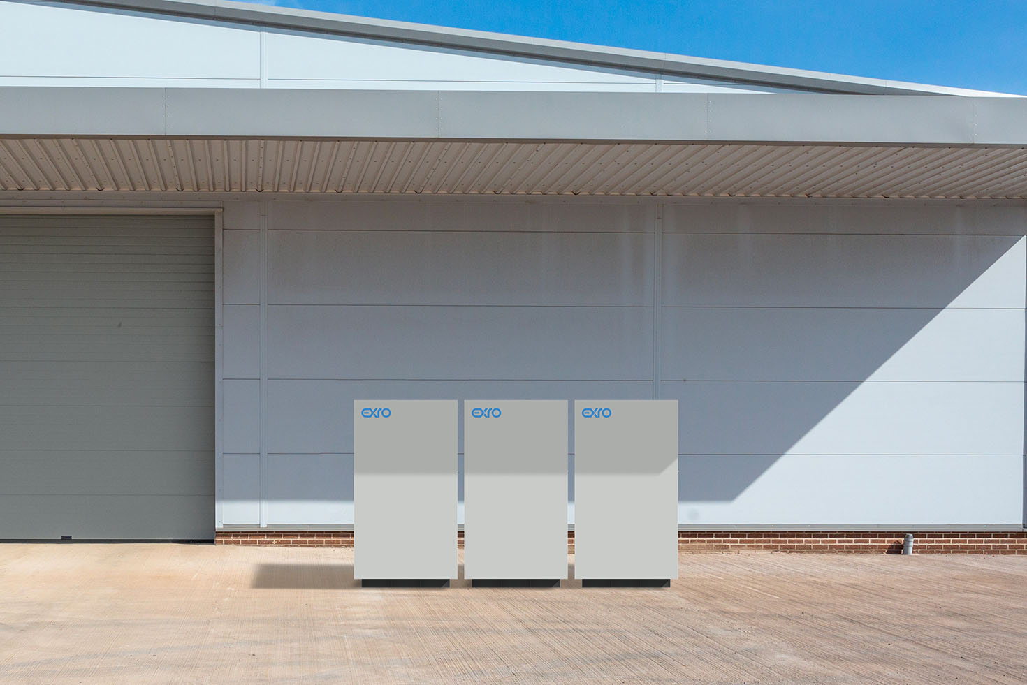 Three Exro 25kW 150kWh Energy Storage Systems outside a small facility.
