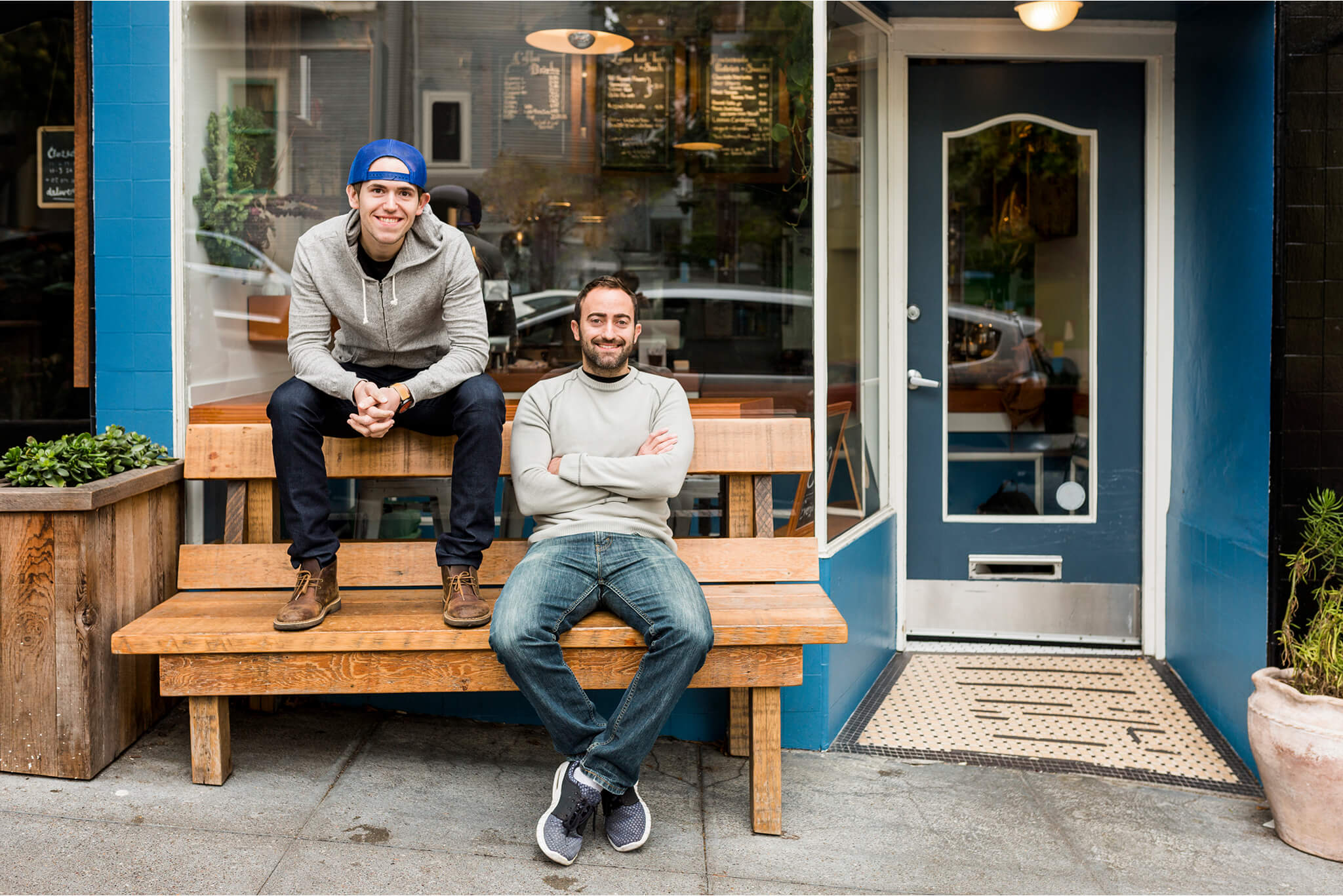 Vancouver small business marketing: Two local business owners in front of independent café, real people driving Vancouver entrepreneurship