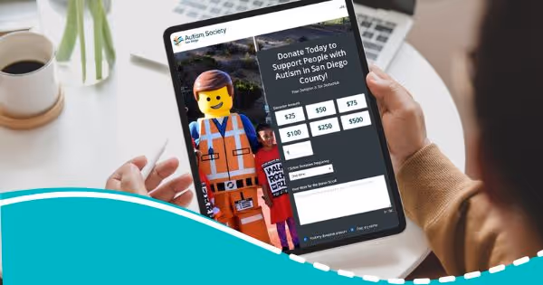 A person looking at the Autism Society San Diego donation website on a tablet.