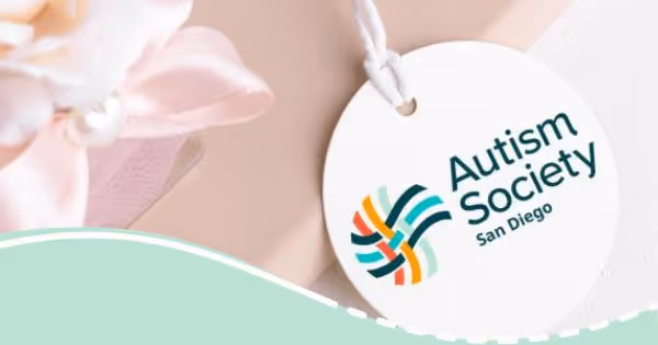 A white tag with the words autism society on it