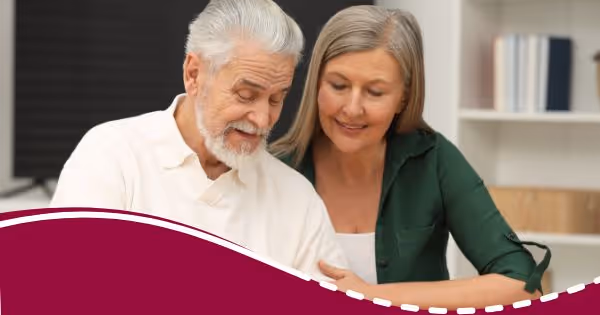 A man and woman looking at something on a table