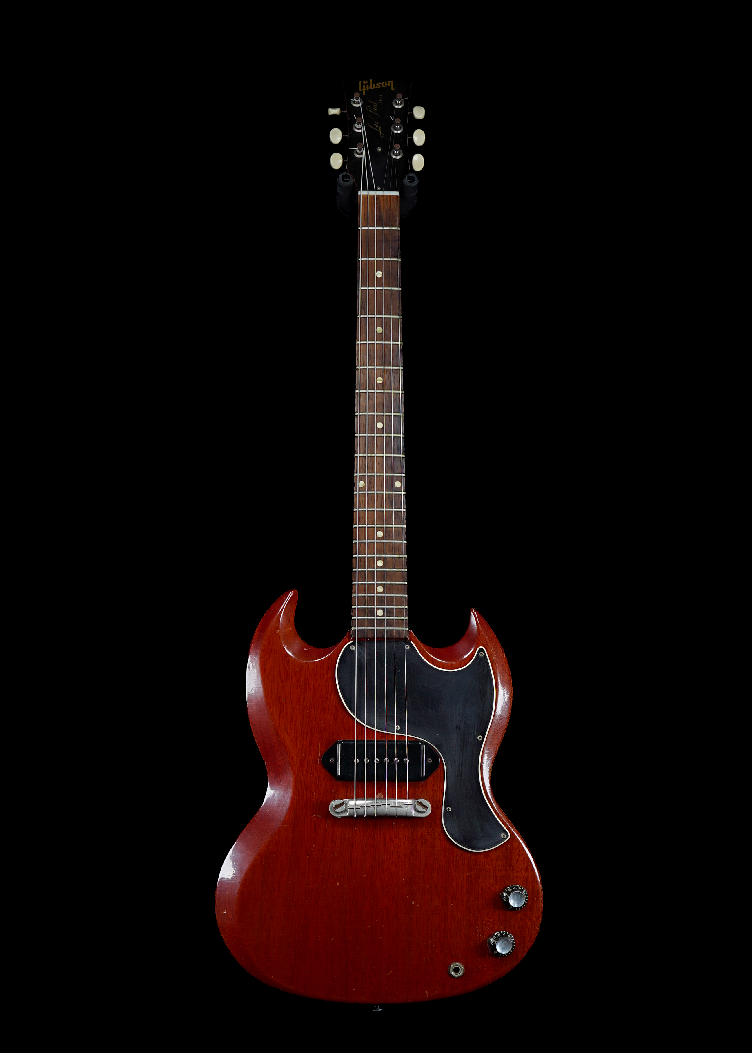 a professional photo of one of the earliest 1962 Gibson Les Paul SG Junior Cherry vintage guitar with Les Paul decal on headstock, taken by Tone Brothers