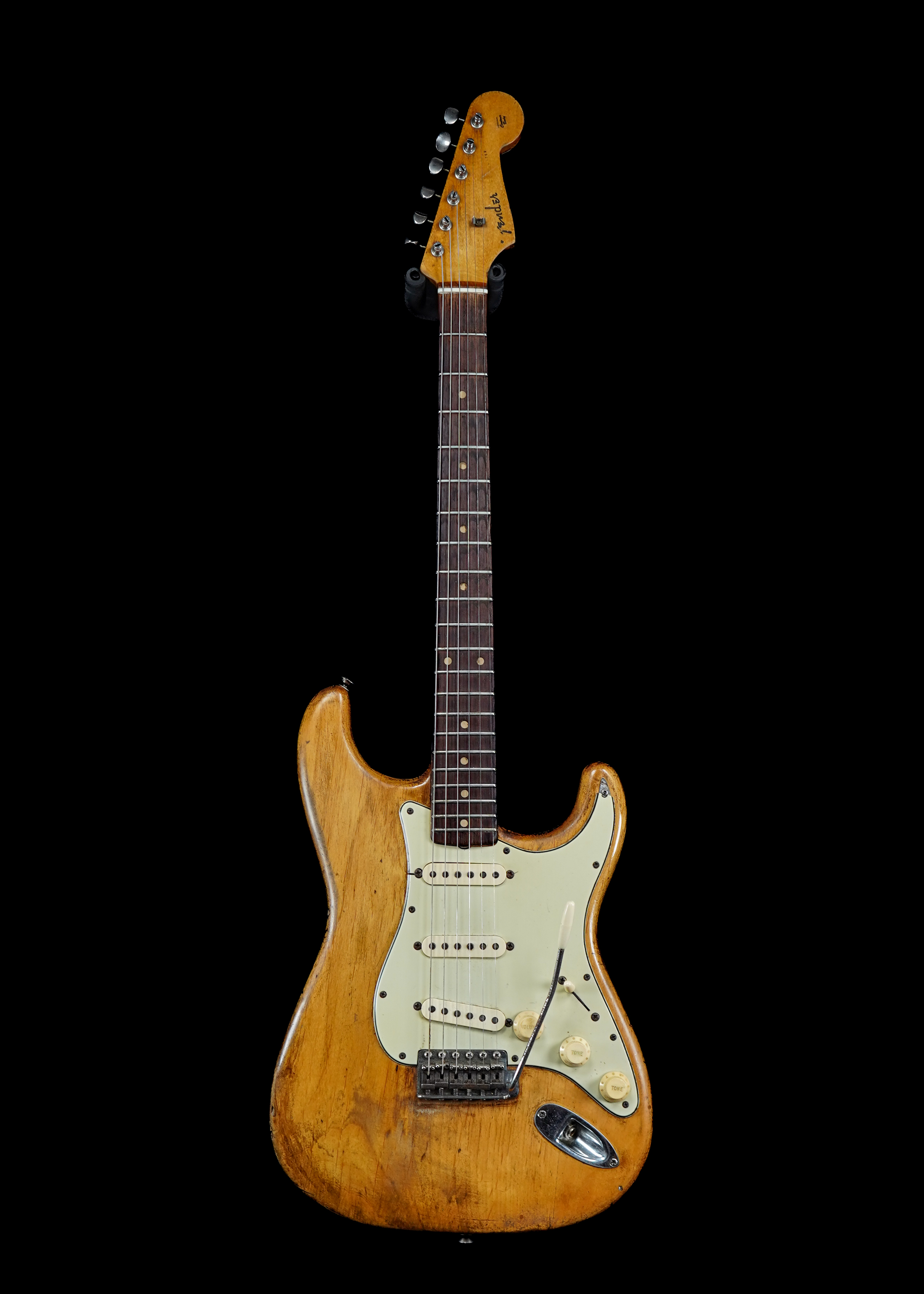 a professional photo of a 1960 Fender Stratocaster Natural by Tone Brothers