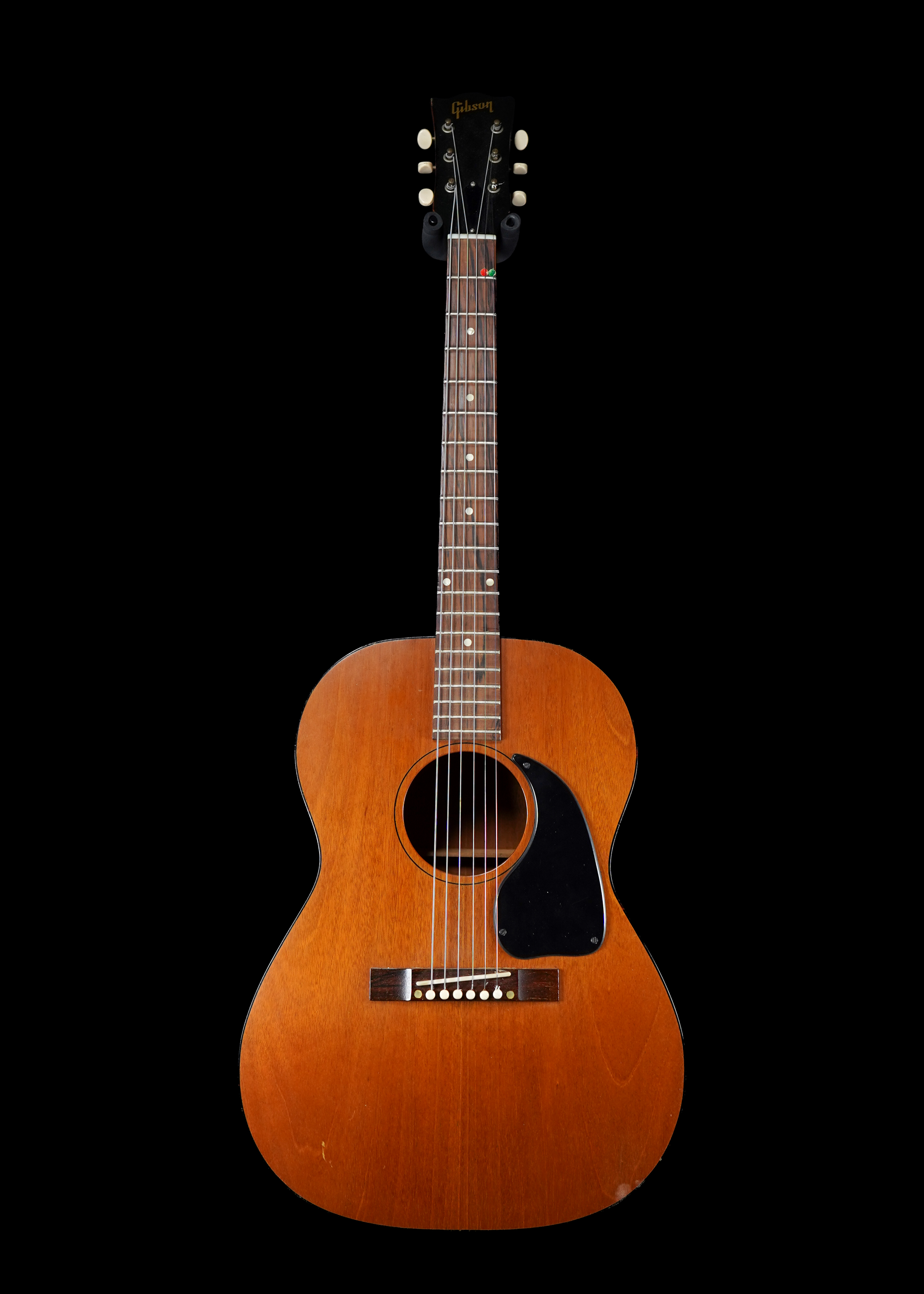 a professional photo of a 1962 Gibson LG-0 Natural by Tone Brothers, the best place to sell my vintage guitar