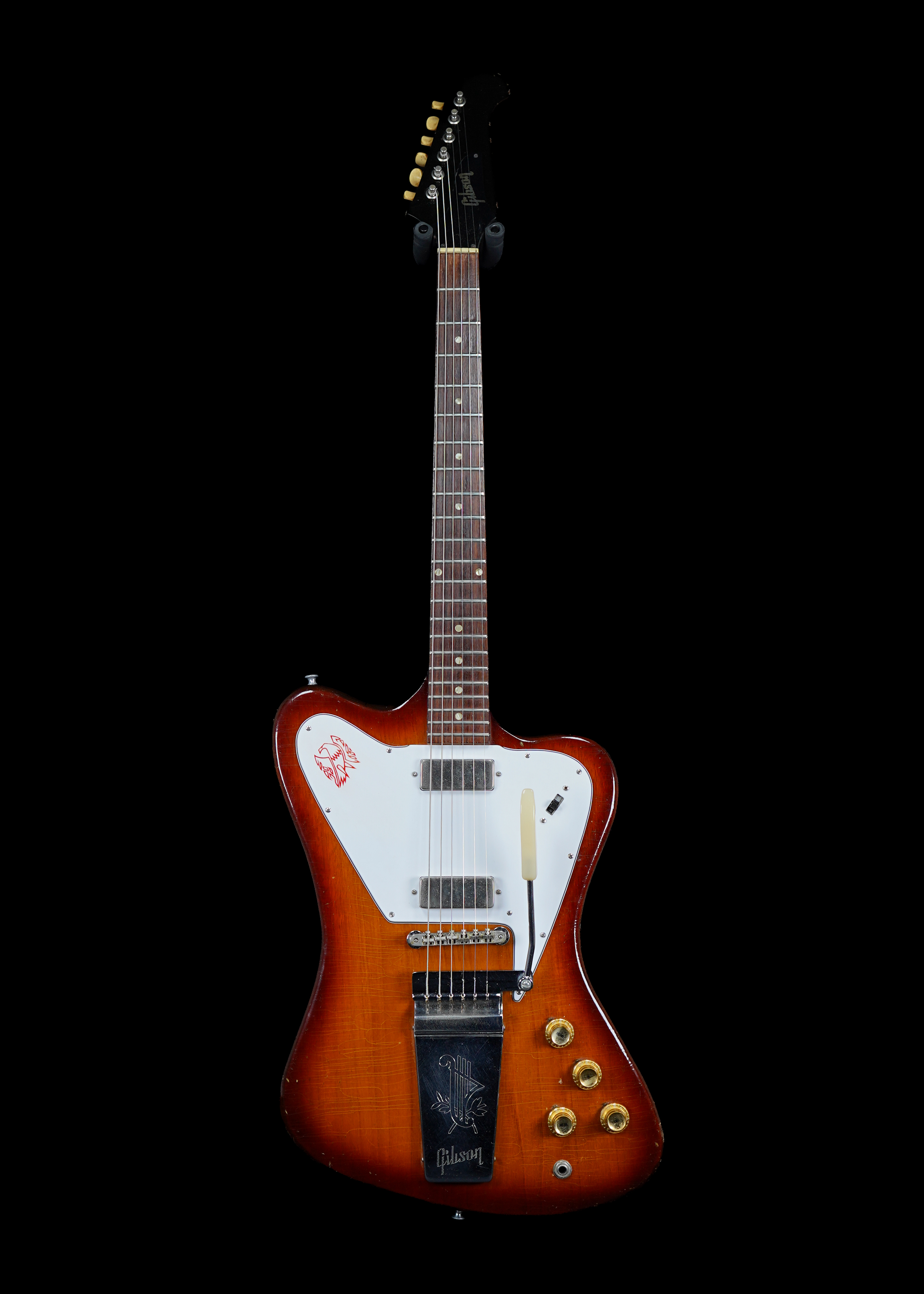 a professional photo of a 1965 Gibson Firebird V Non-Reverse Sunburst vintage guitar by Tone Brothers, the best place to sell my vintage guitar