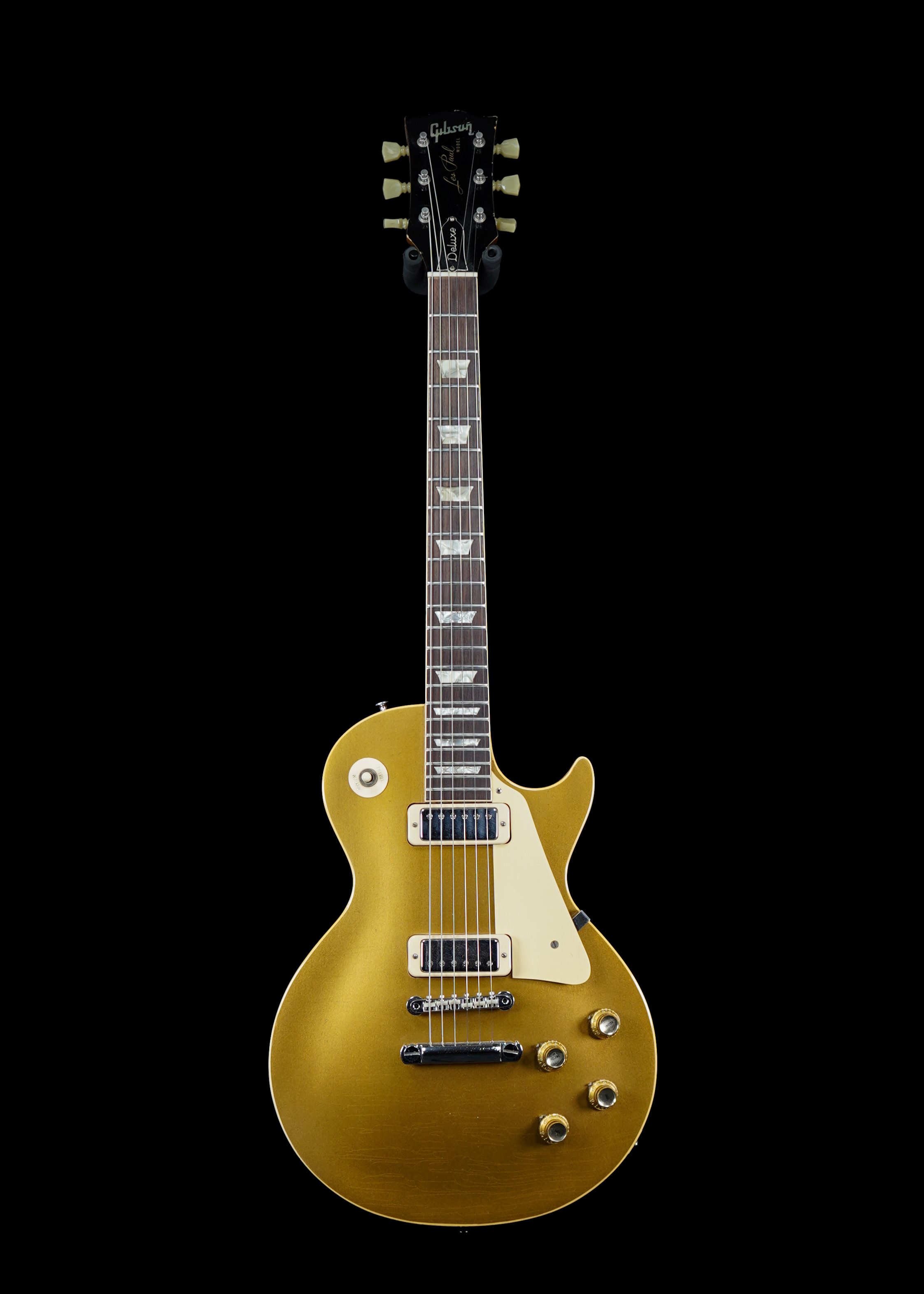 a professional photo of an original 1969 Gibson Les Paul Deluxe Goldtop vintage guitar by Tone Brothers, the best place to sell my vintage Gibson Les Paul guitar