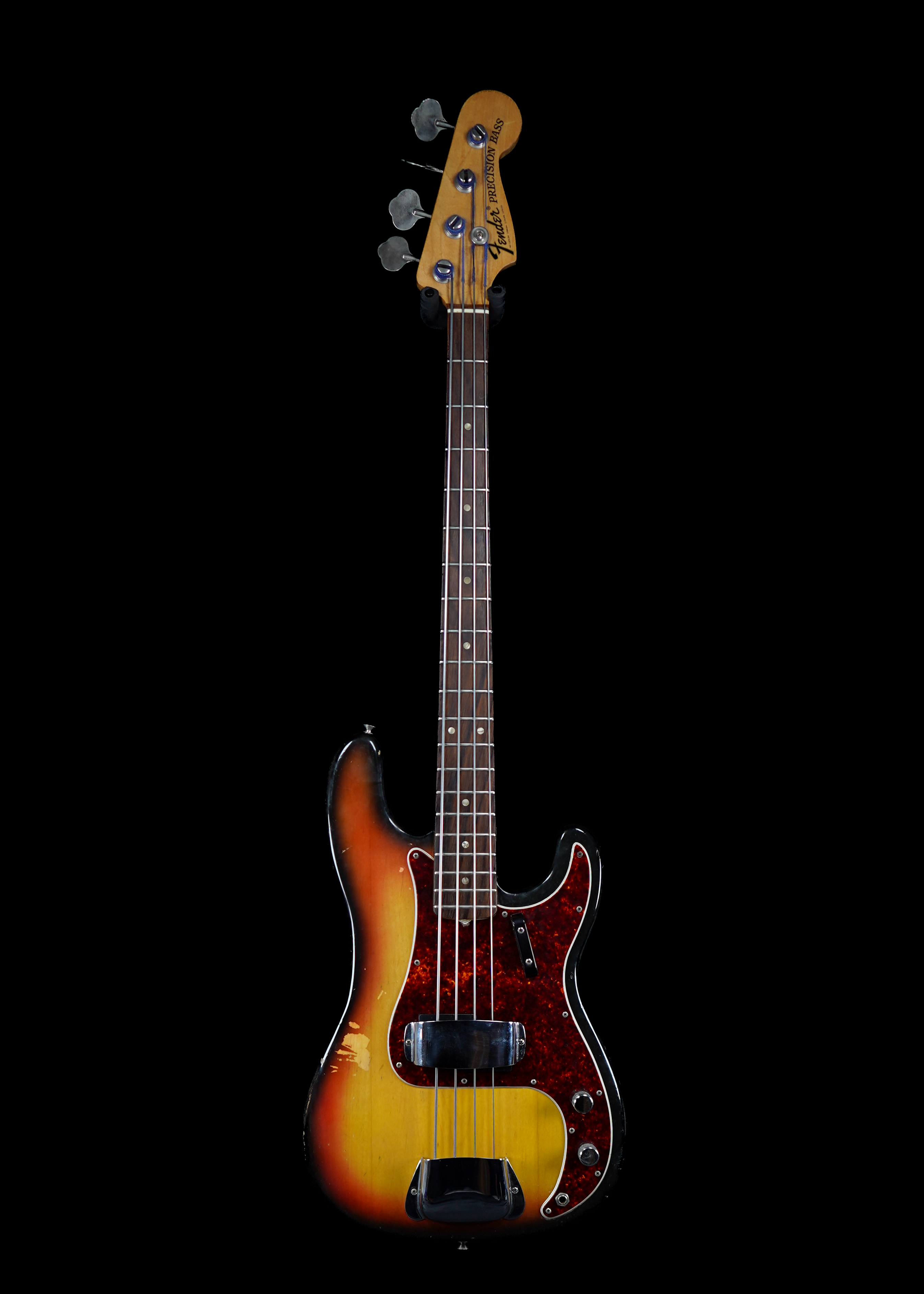 a professional photo of a 1969 Fender Precision Bass Sunburst guitar by Tone Brothers, the best place to sell my vintage Fender bass guitar