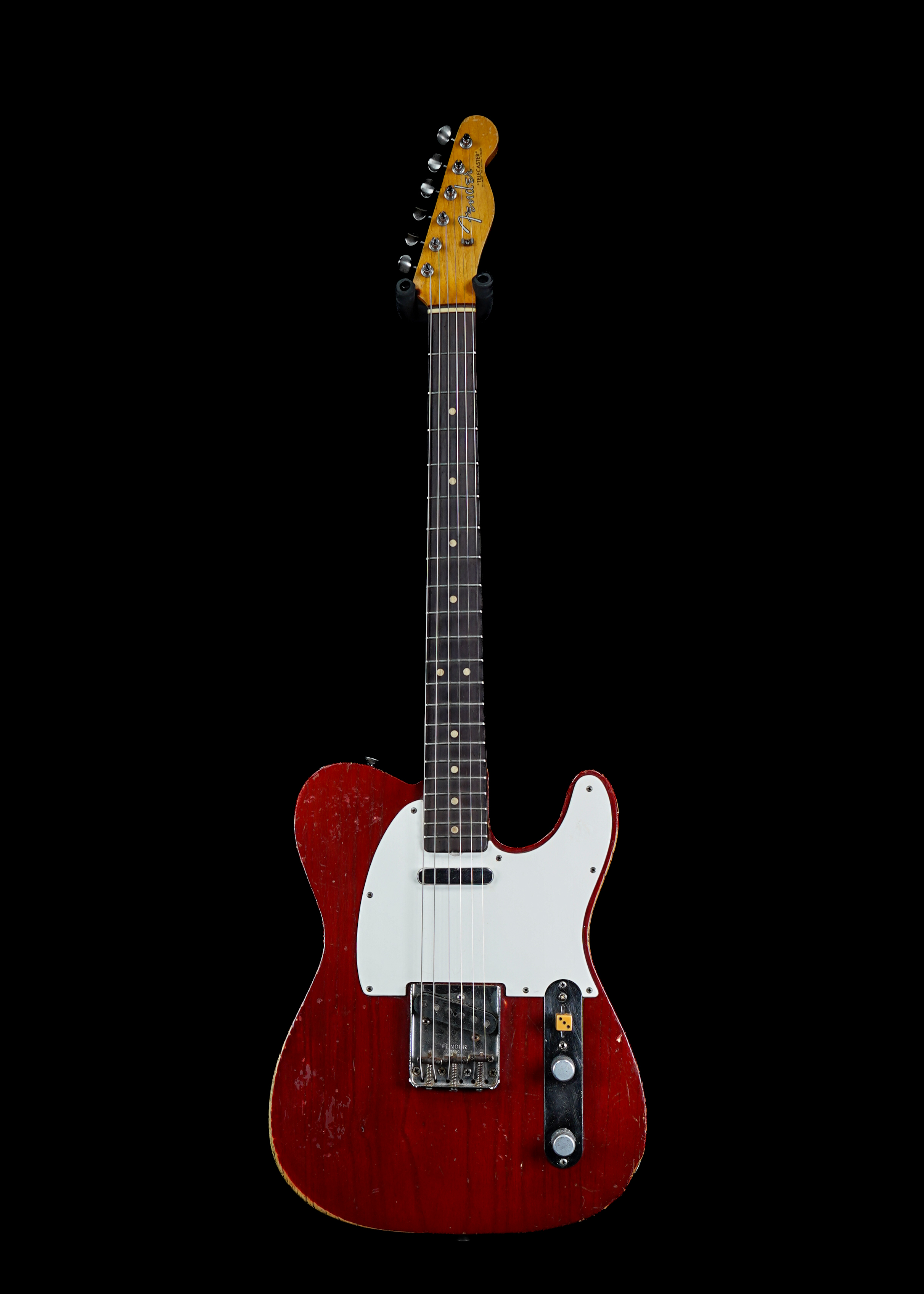 a professional photo of a 1963 Fender Telecaster Lucy Red by Tone Brothers, the best place to sell my vintage guitar