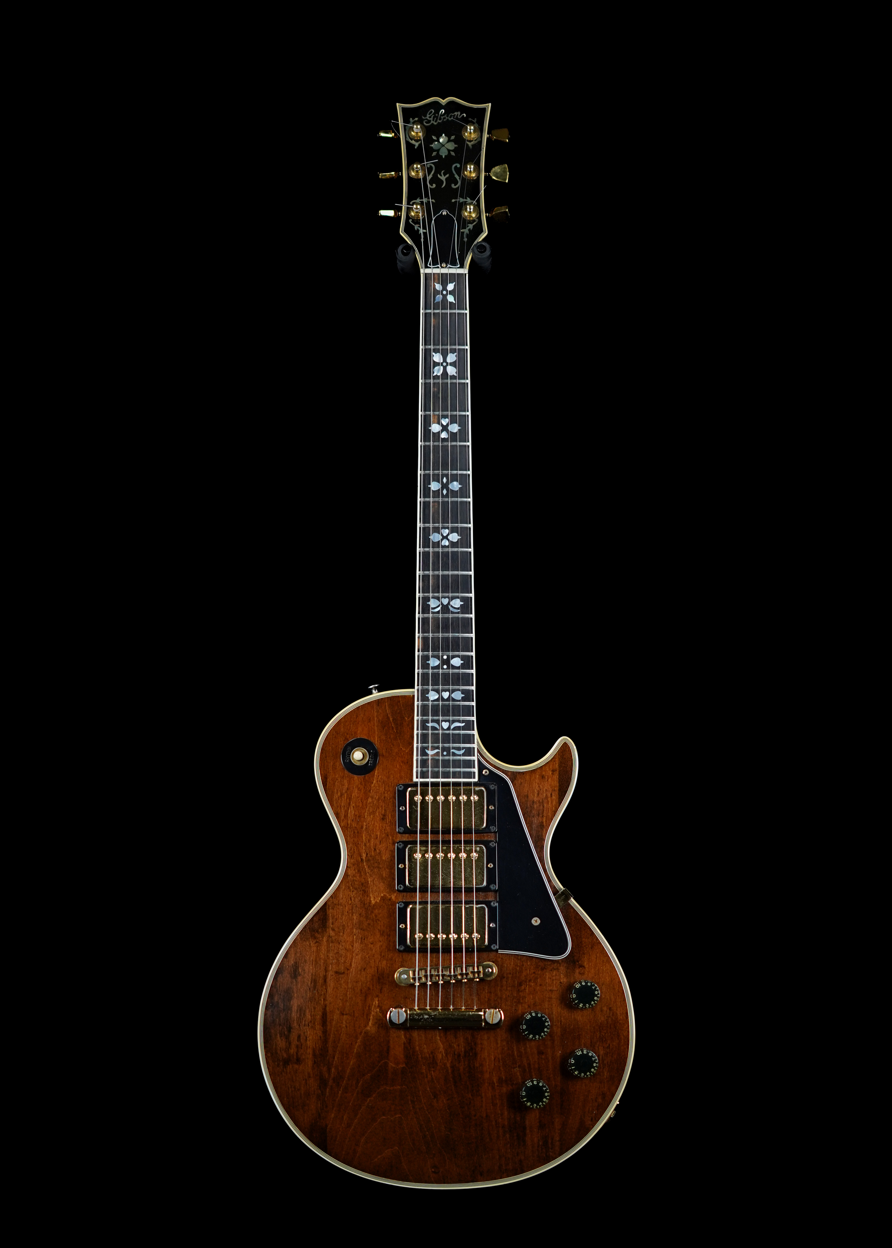 a professional photo of a 1977 Gibson Les Paul Artisan guitar by Tone Brothers, the best place to sell my vintage Gibson Les Paul