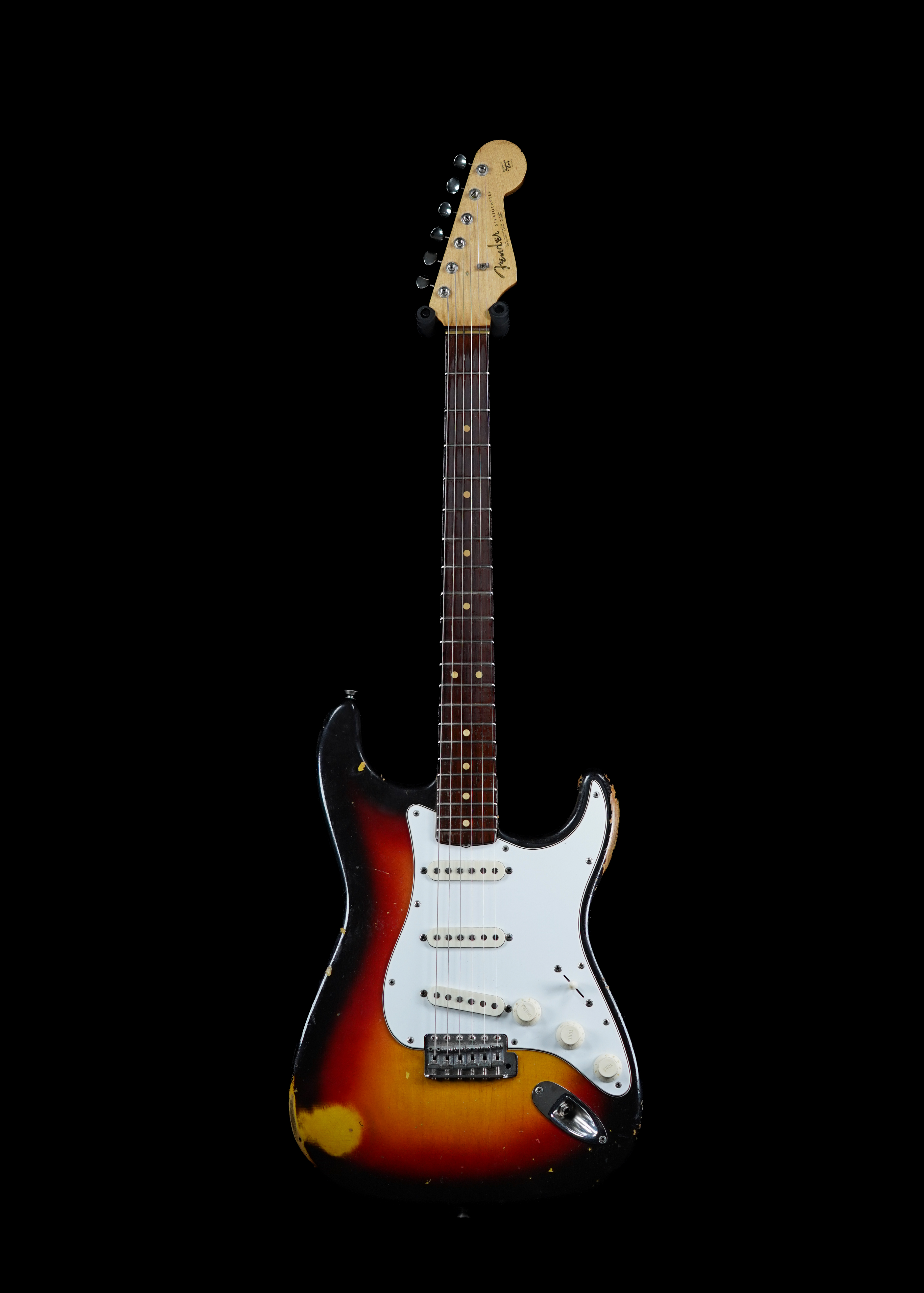 a professional photo of a 1963 Fender Stratocaster Sunburst pre-CBS guitar by Tone Brothers, the best place to sell my vintage Fender guitar and the most credible vintage guitar dealer