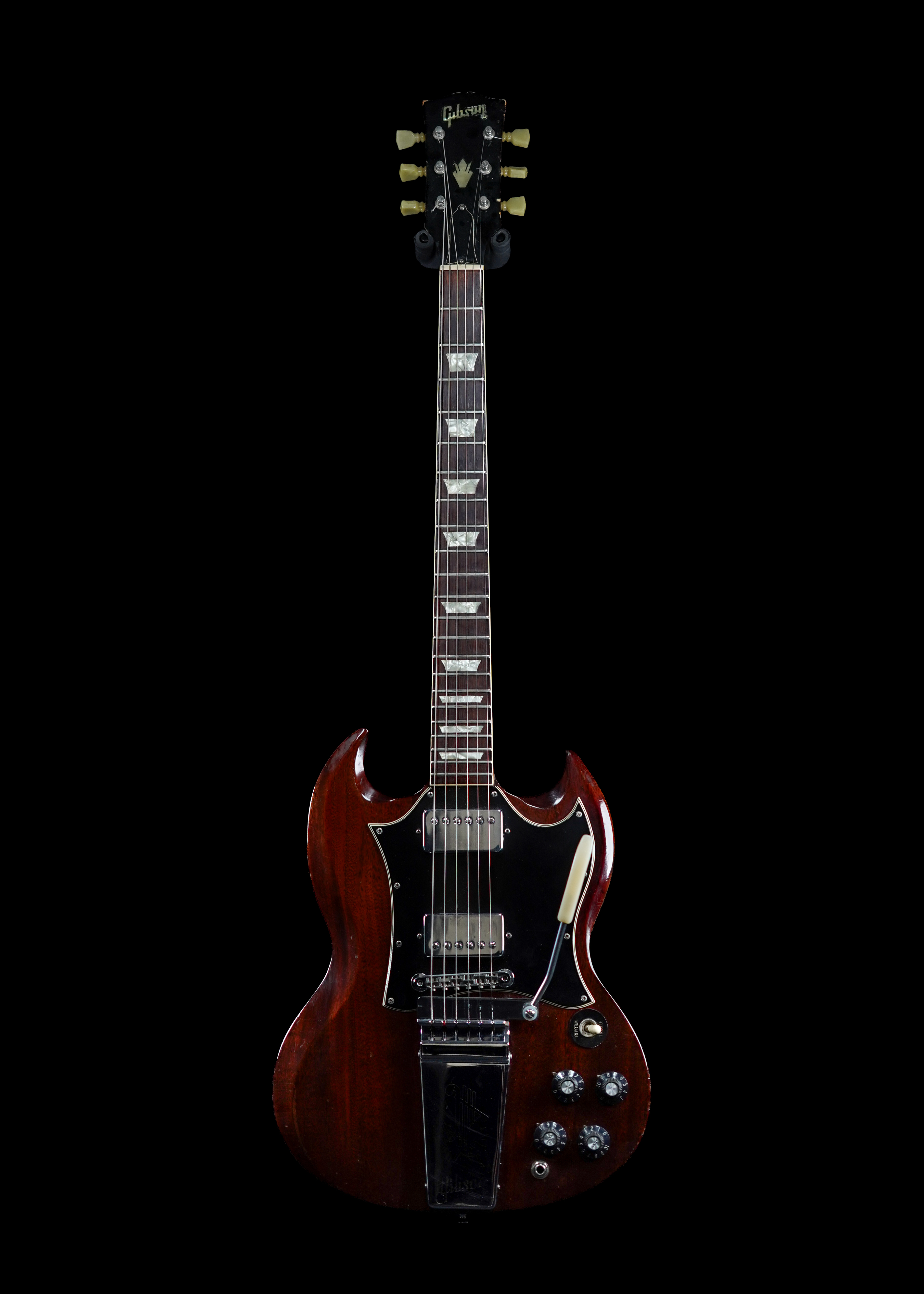 a professional HD photo of a 1969 Gibson SG Standard Cherry vintage electric guitar by Tone Brothers, the best place to sell my vintage Gibson guitar