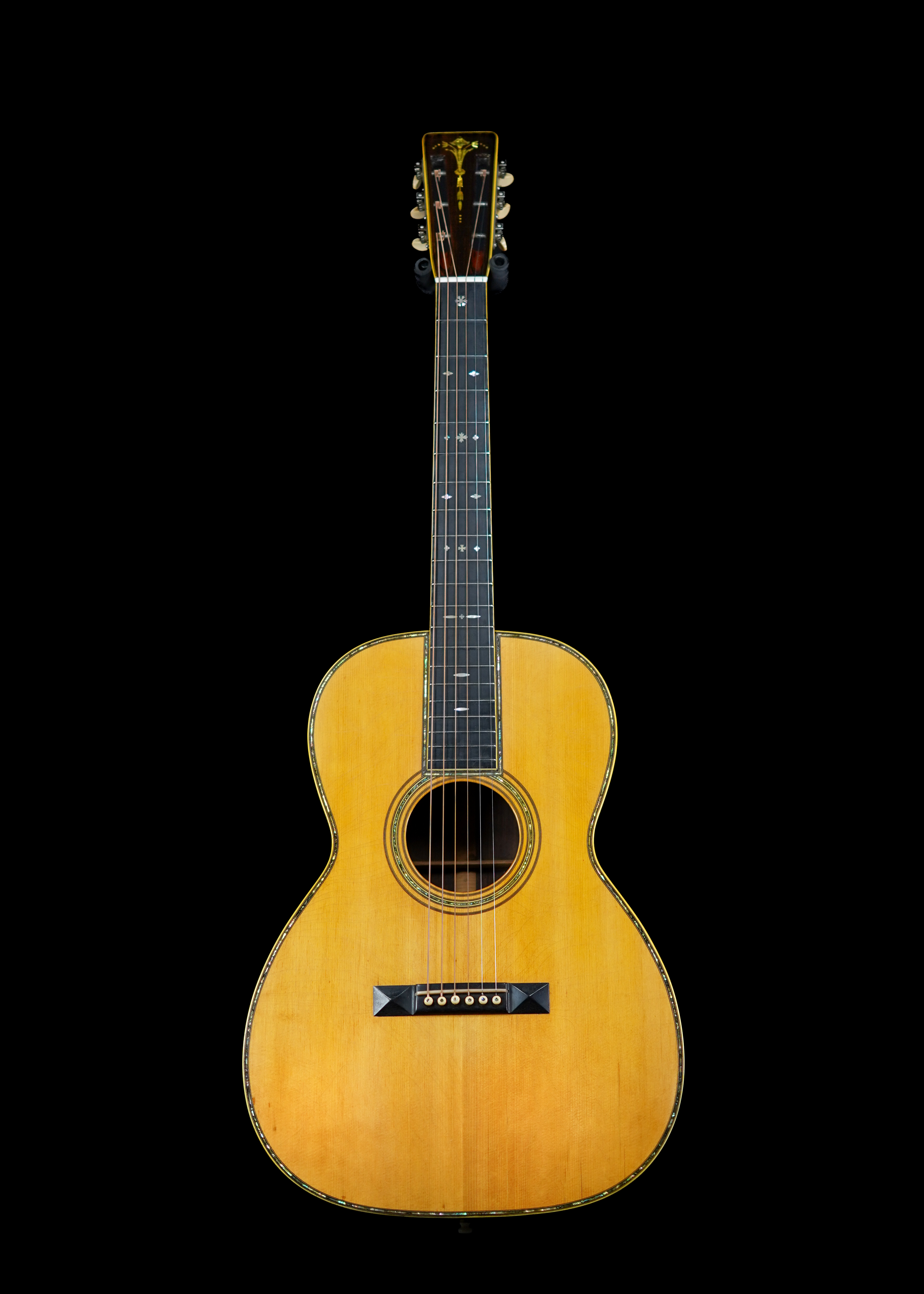 a professional photo of a pre-war 12-fret, 1927 Martin 000-45 Natural by Tone Brothers, Tone Brothers is the best place to sell my pre-war vintage Martin acoustic guitar