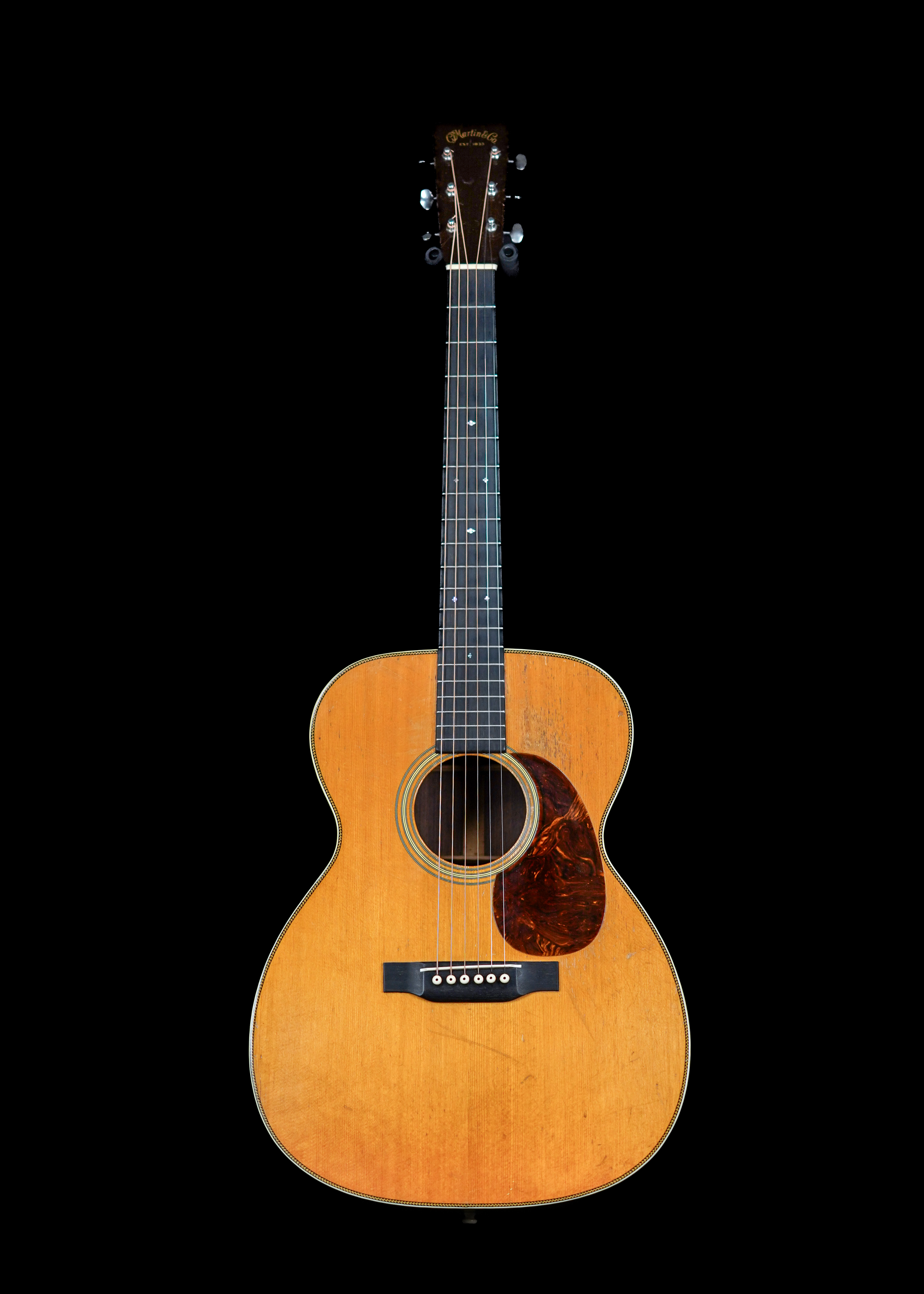 a professional photo of a real vintage 1936 Martin 000-28 Natural acoustic guitar by Tone Brothers, the best place to sell my pre-war Martin guitar