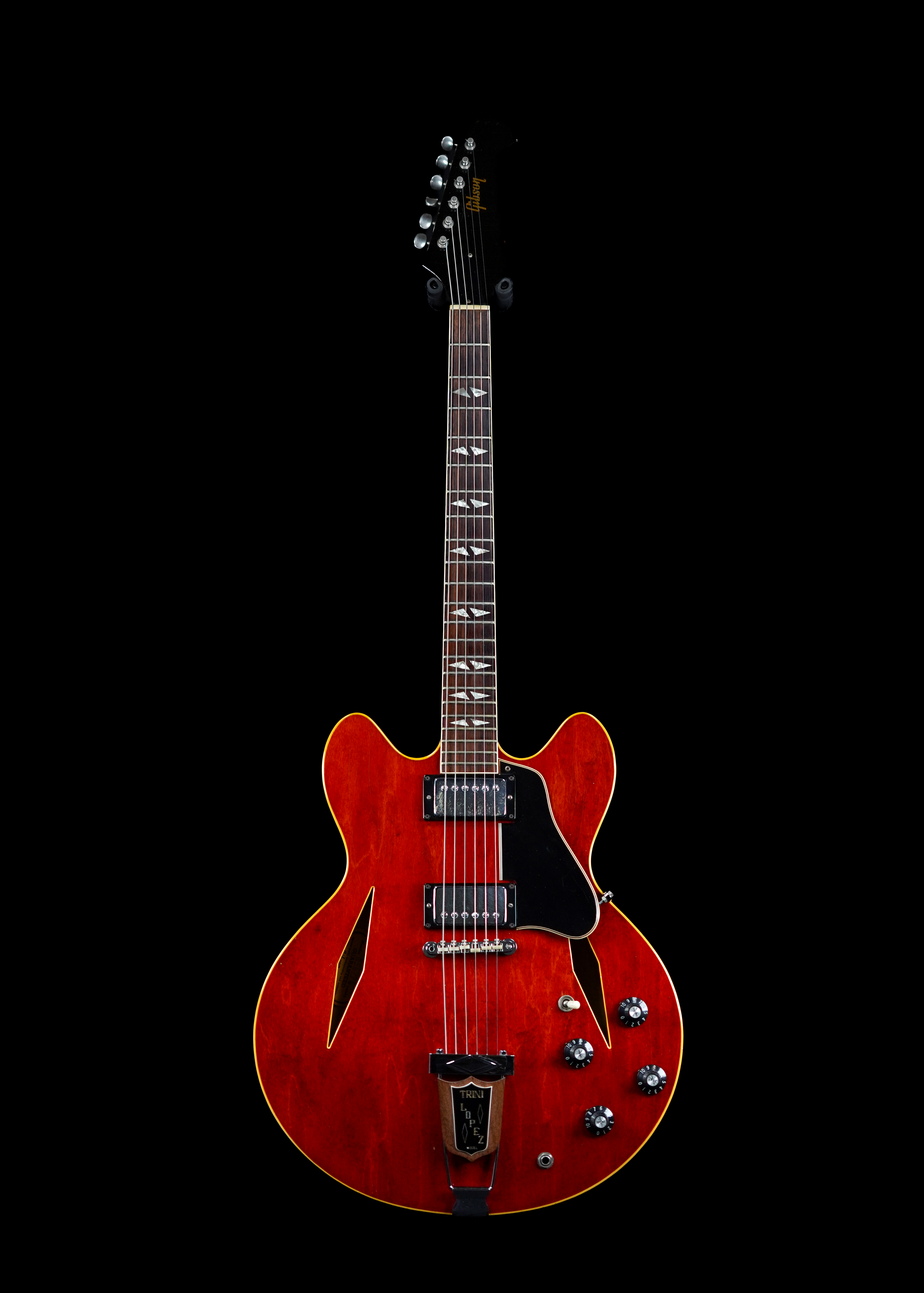 a professional photo of a 1967 Gibson Trini Lopez Cherry vintage electric guitar by Tone Brothers, the best place to sell my vintage GIbson guitar