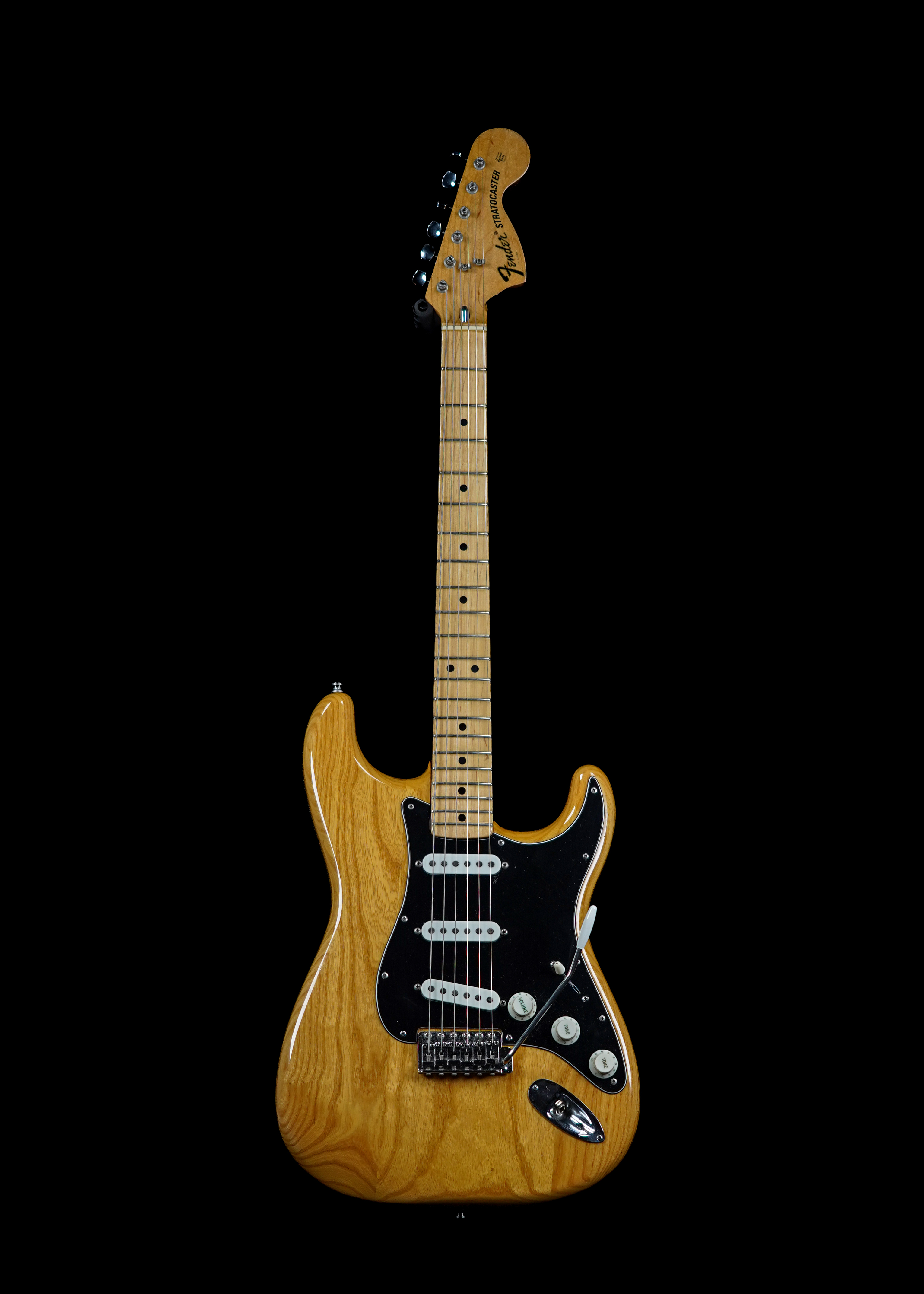 a professional photo of a 1975 Fender Stratocaster Natural by Tone Brothers, the best place to sell my Fender Stratocaster