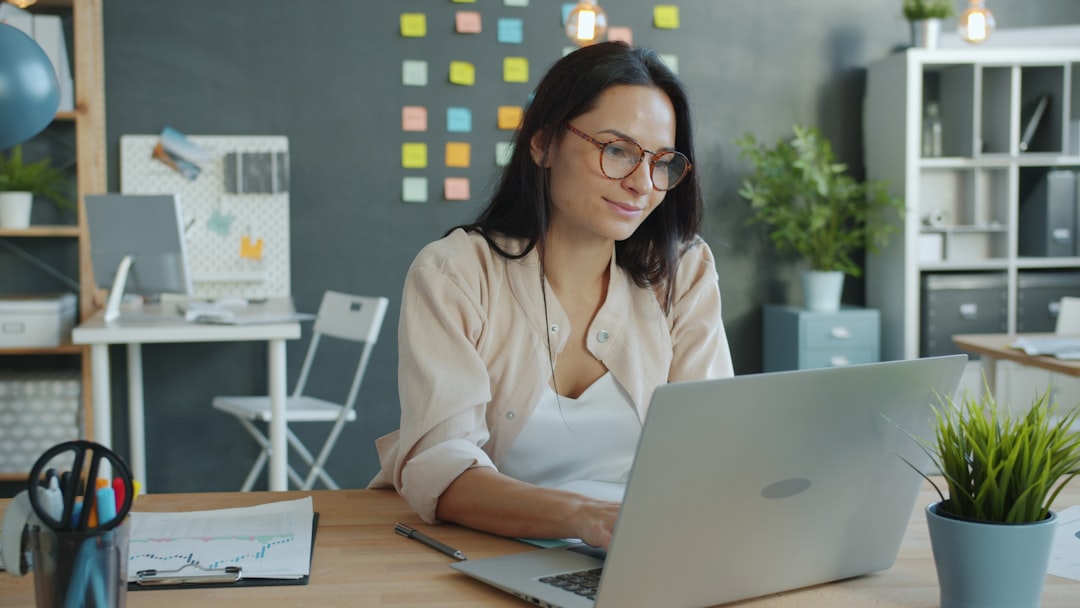 Professional working on laptop in a modern APAC office — Photo by Vitaly Gariev on Unsplash