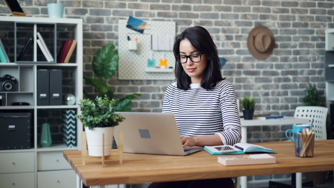 Finance professional reviewing accounts on a laptop in a modern office — Photo by Vitaly Gariev on Unsplash