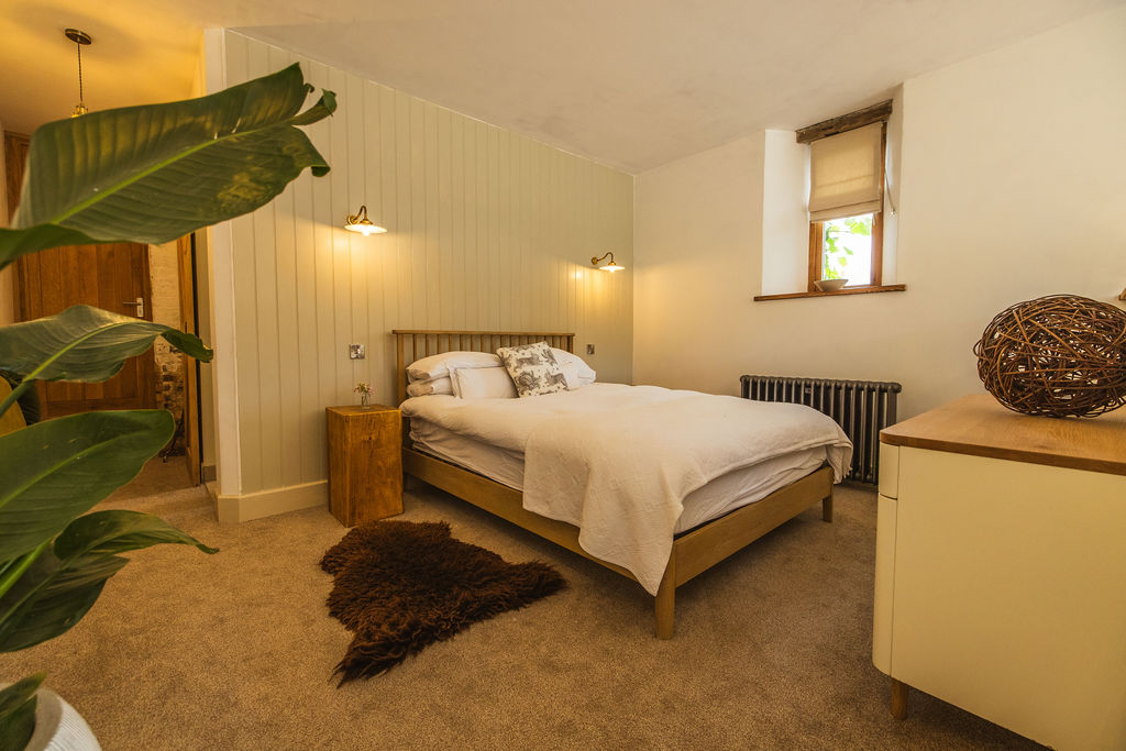 The Shippon — king-size bed in restored barn at Borough Farm, Devon