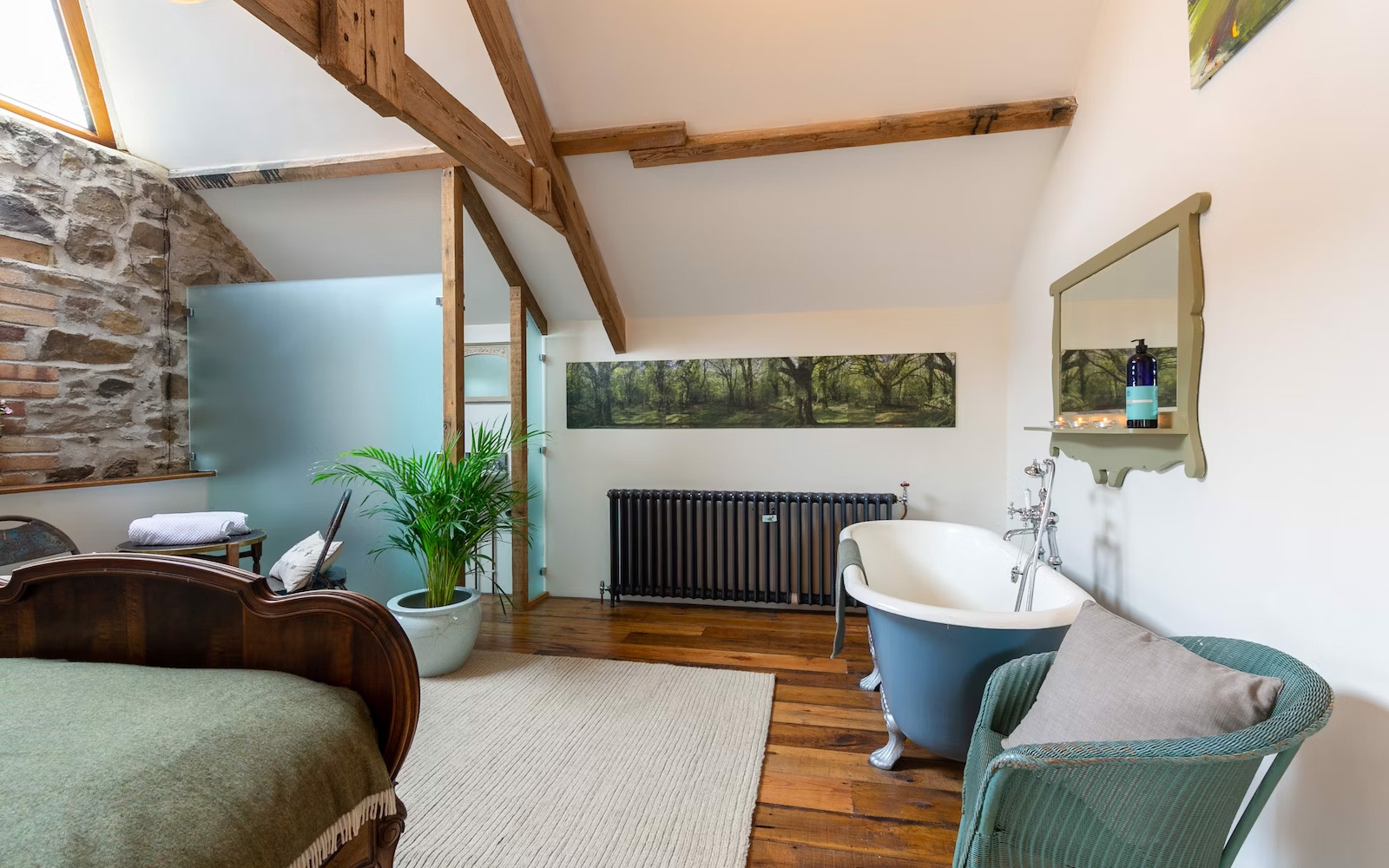 The Granary — antique French bed beneath the glass apex, Borough Farm