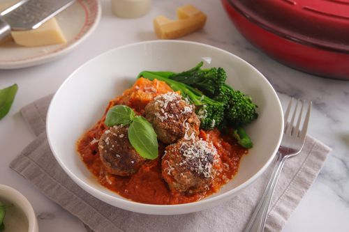 Meatballs served over creamy kumara mash with a hidden veg tomato sauce and broccolini – a cosy, crowd-pleasing seasonal dinner.