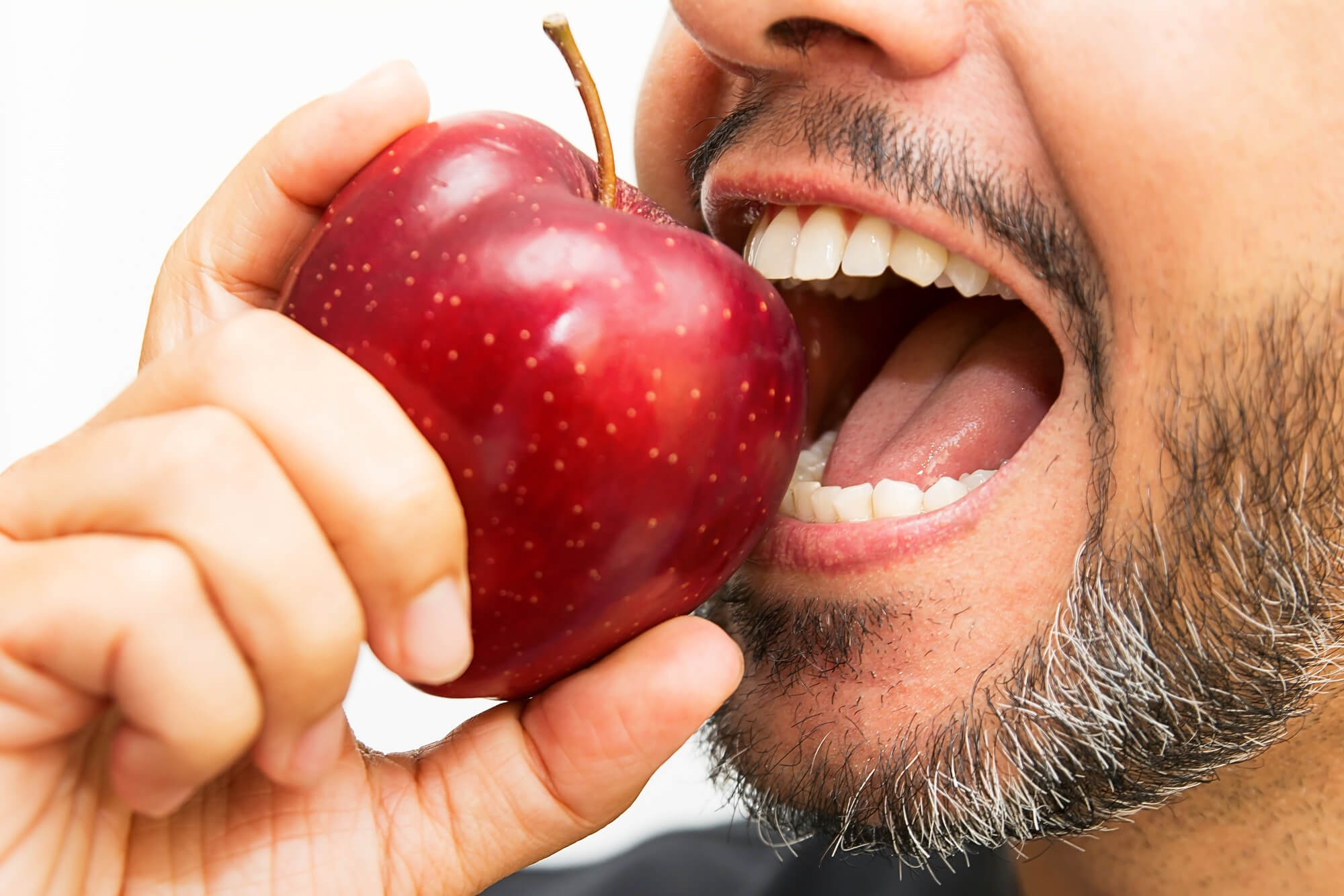 man wearing Dental Implants 33062 biting into an apple