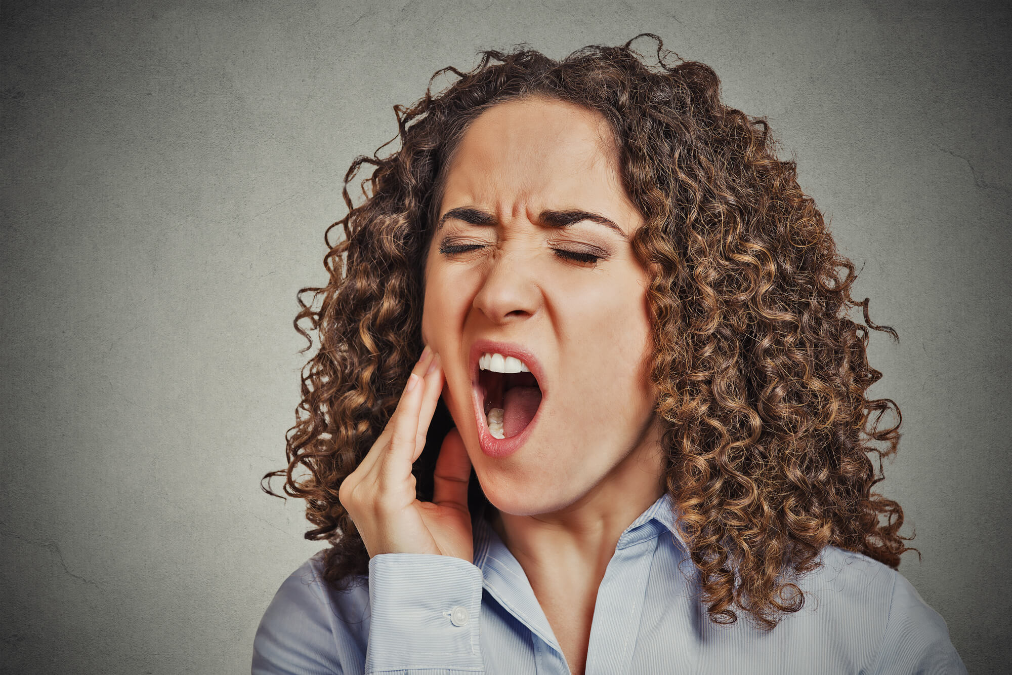 woman in pain needing Root Canal Pompano Beach