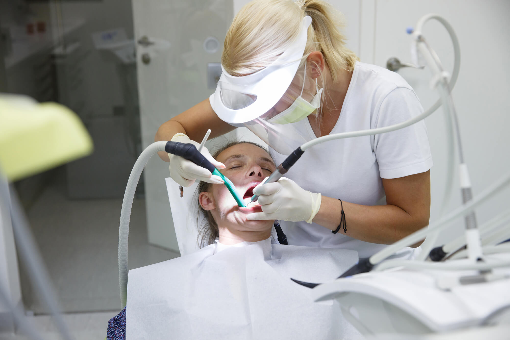 Periodontist Pompano Beach cleaning patient's teeth