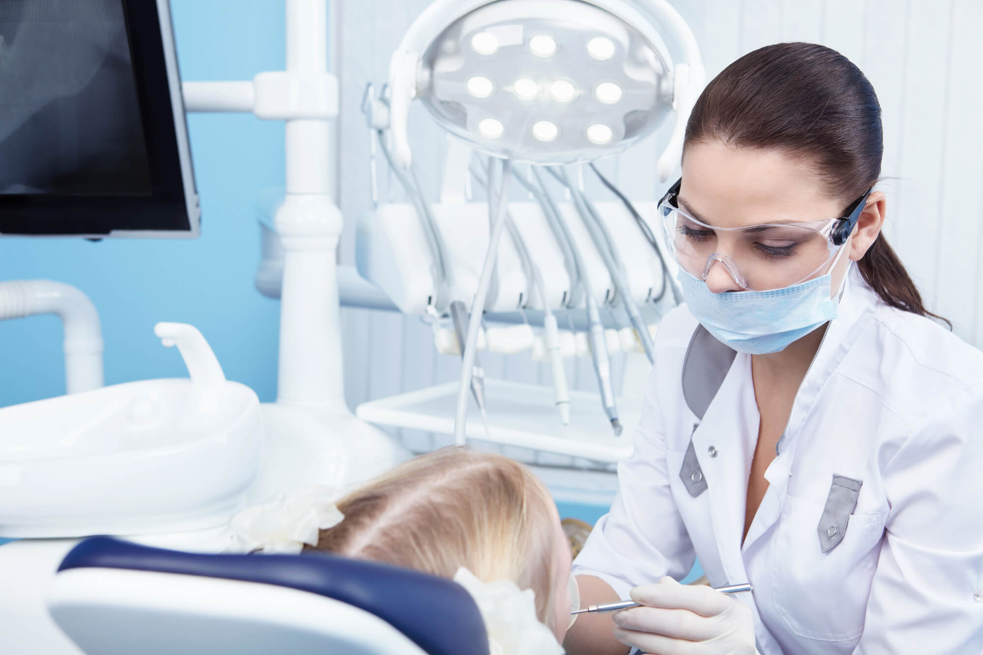 Dentist Pompano Beach checking patient's teeth and gums