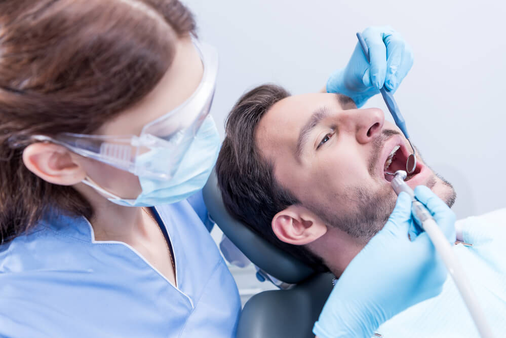 Dentist 33062 checking a patient.