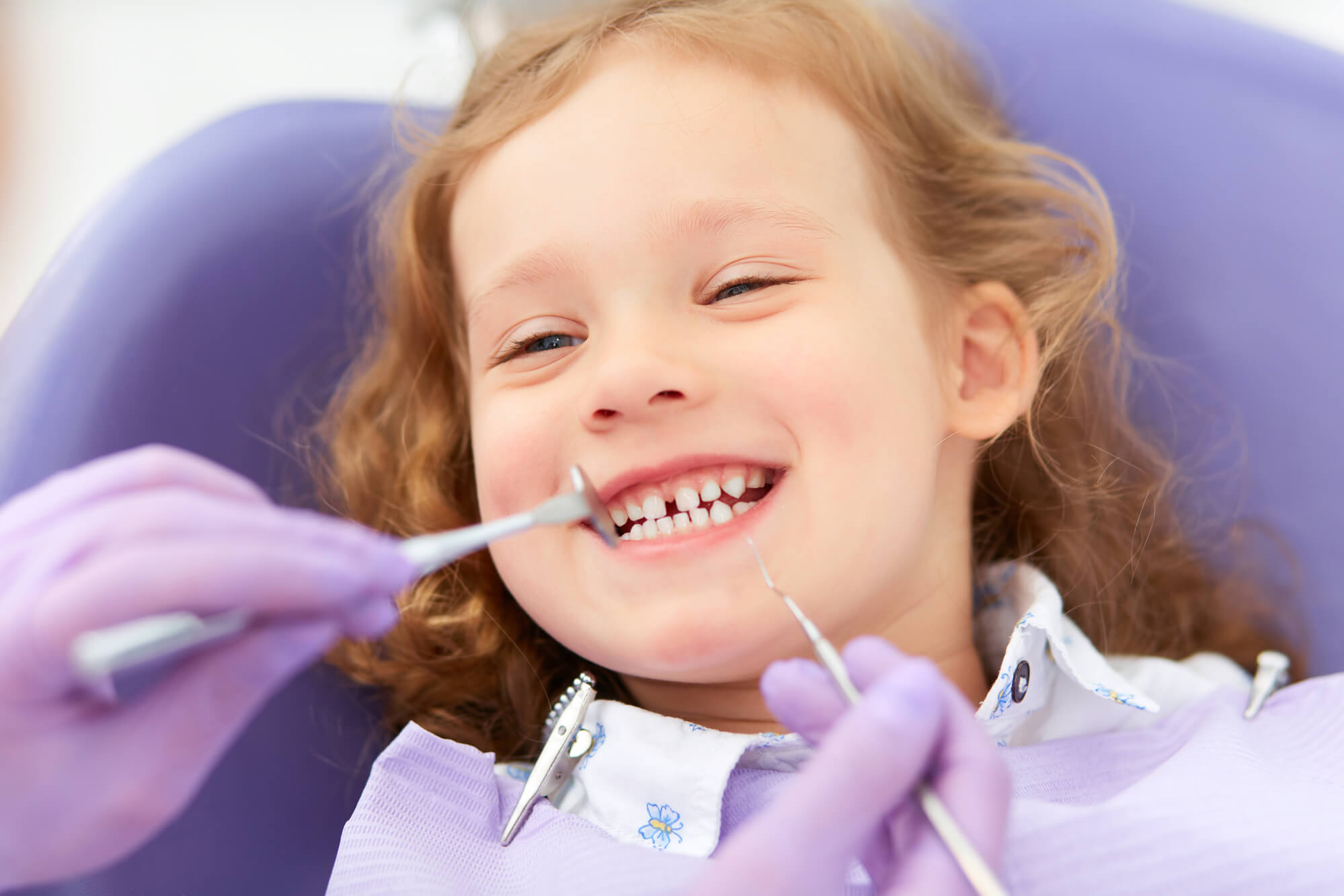 Dentist in Pompano Beach examining child's teeth