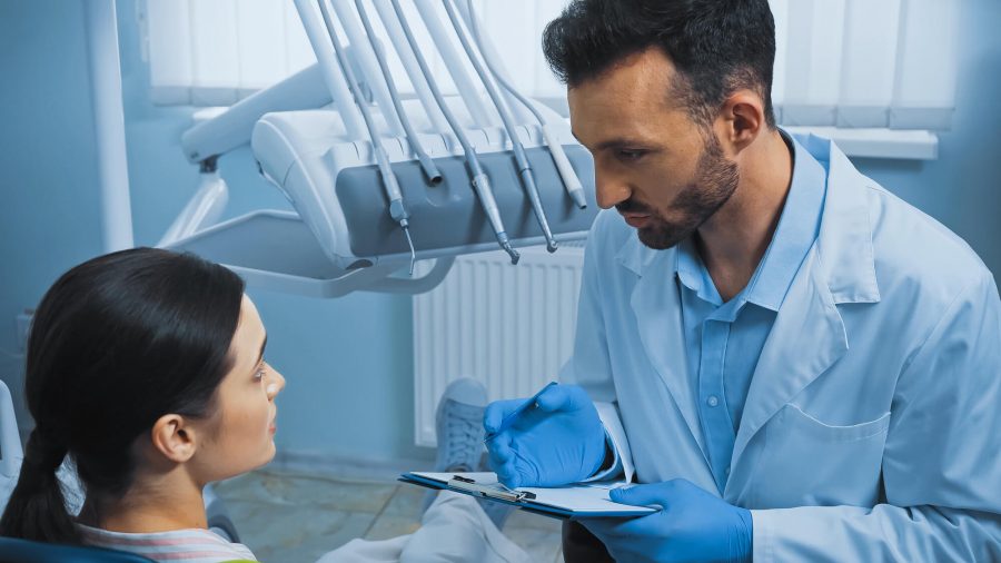 Periodontist in Pompano Beach checking patient