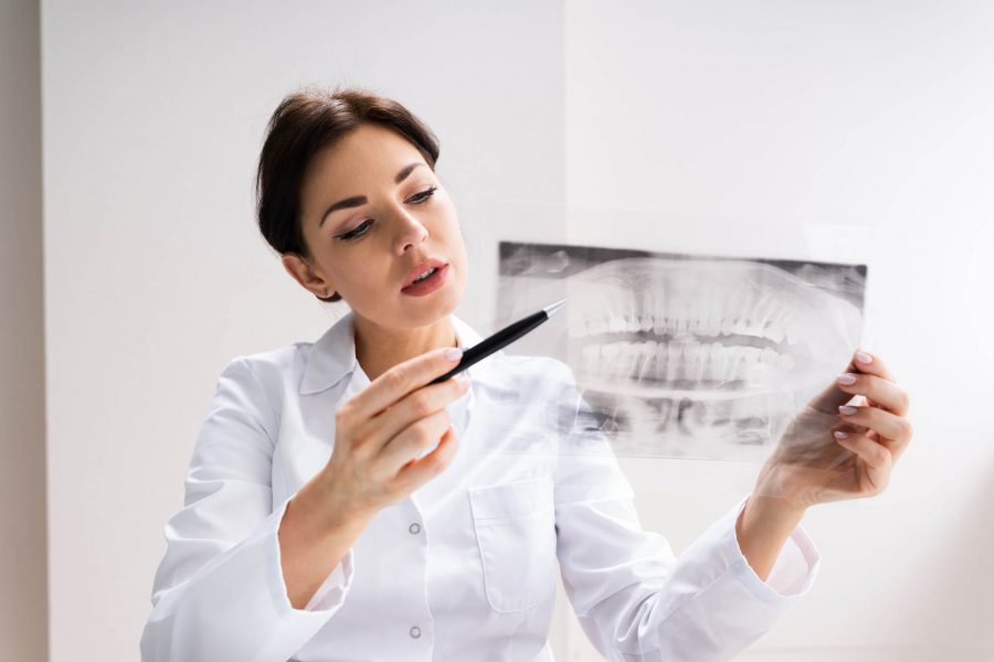 Orthodontist in 33062 checking x-ray