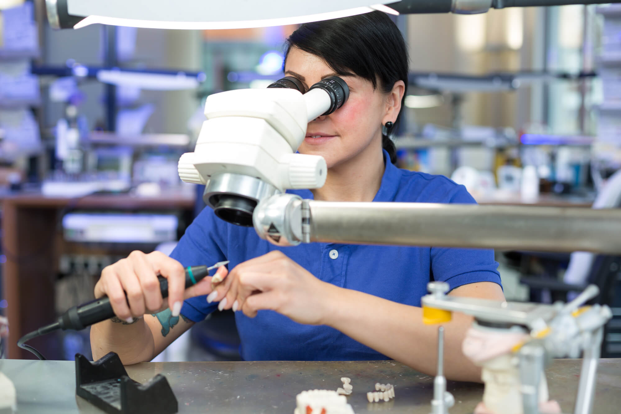technician fixes dental crown for dental implants in 33062