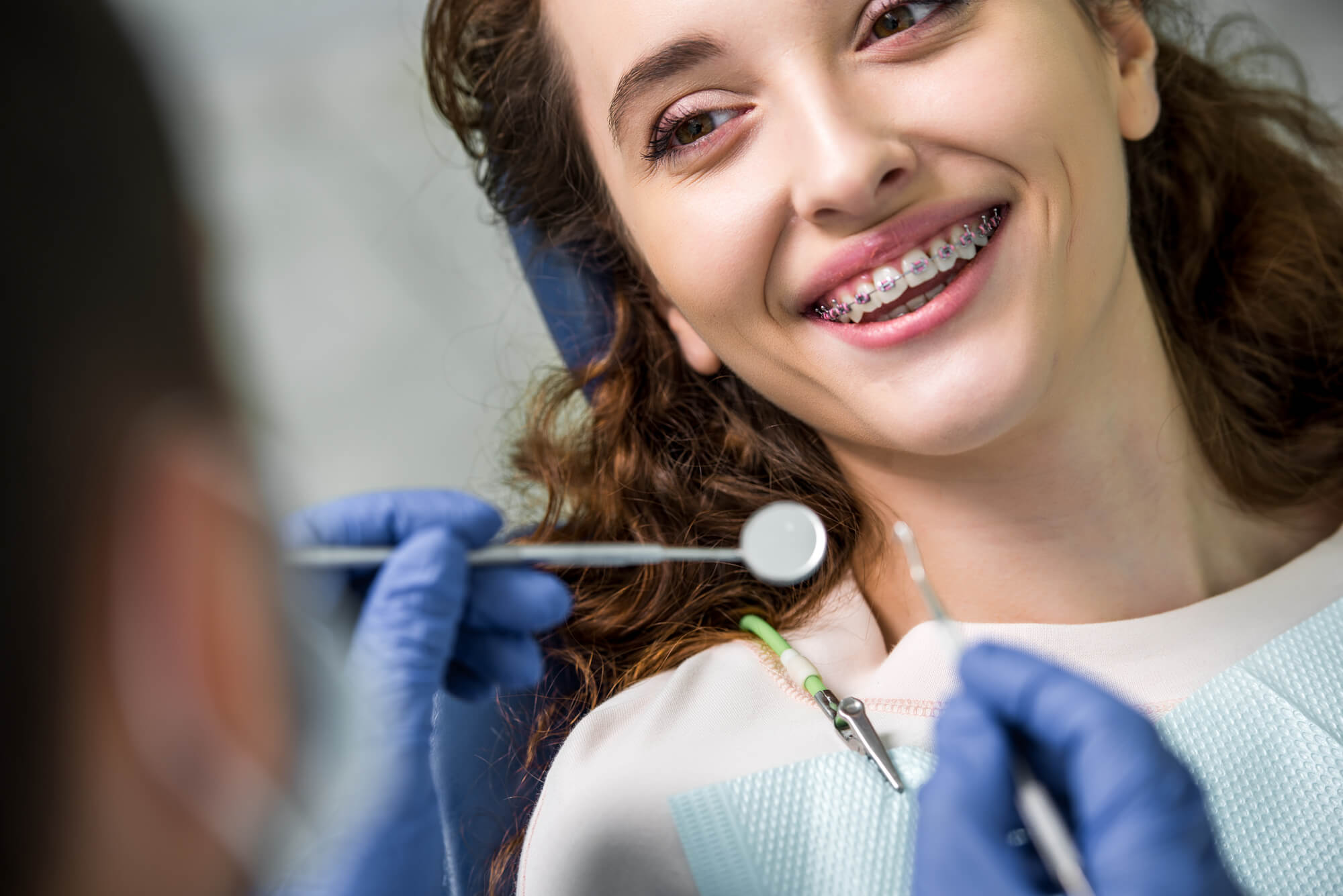 dentist and patient with her new braces in pompano beach