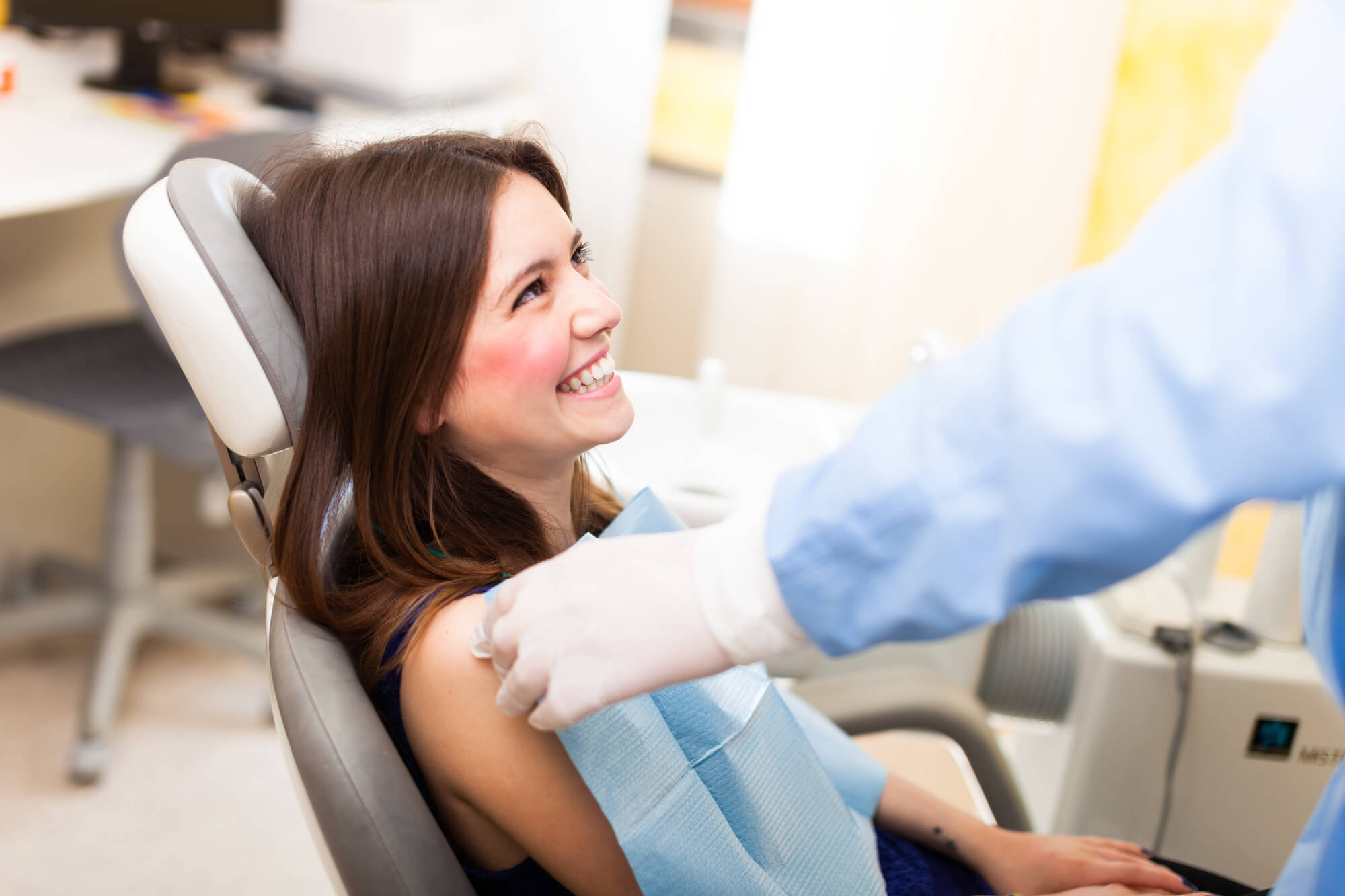 patient smiling at her prosthodontist in Pompano Beach