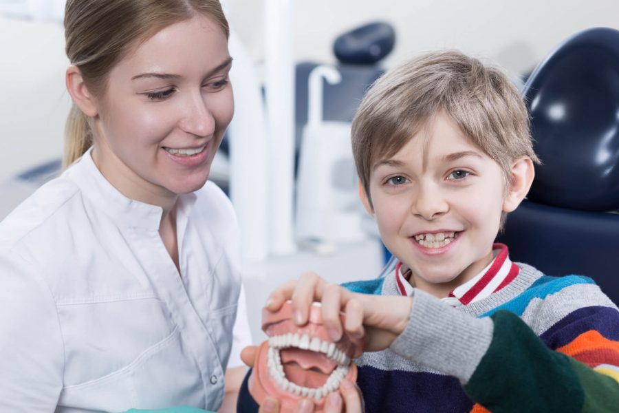 Child showing Dentures in Pompano Beach
