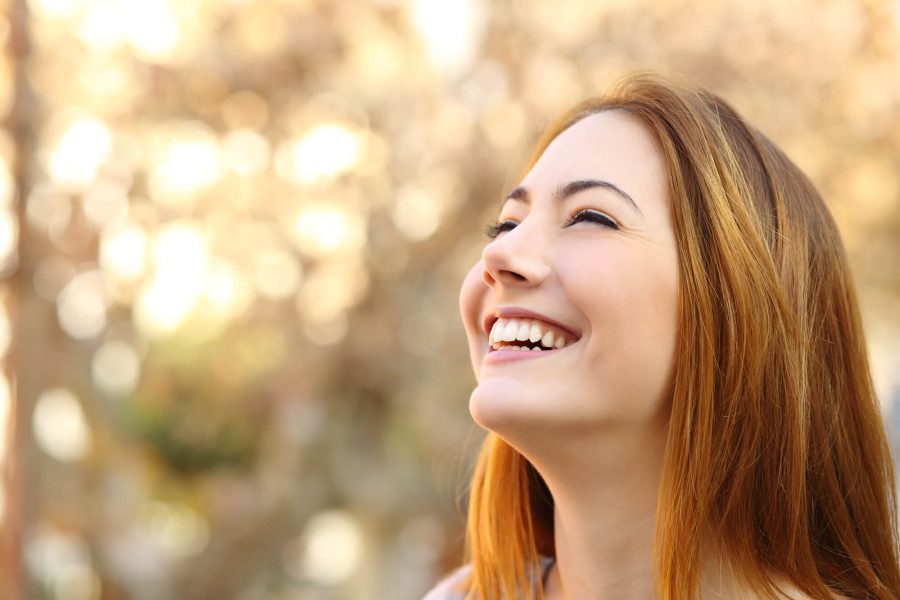 woman smiling after a visit with her Dentist in Pompano Beach 