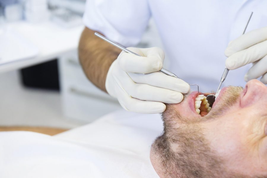 Periodontist in Pompano Beach checking patient