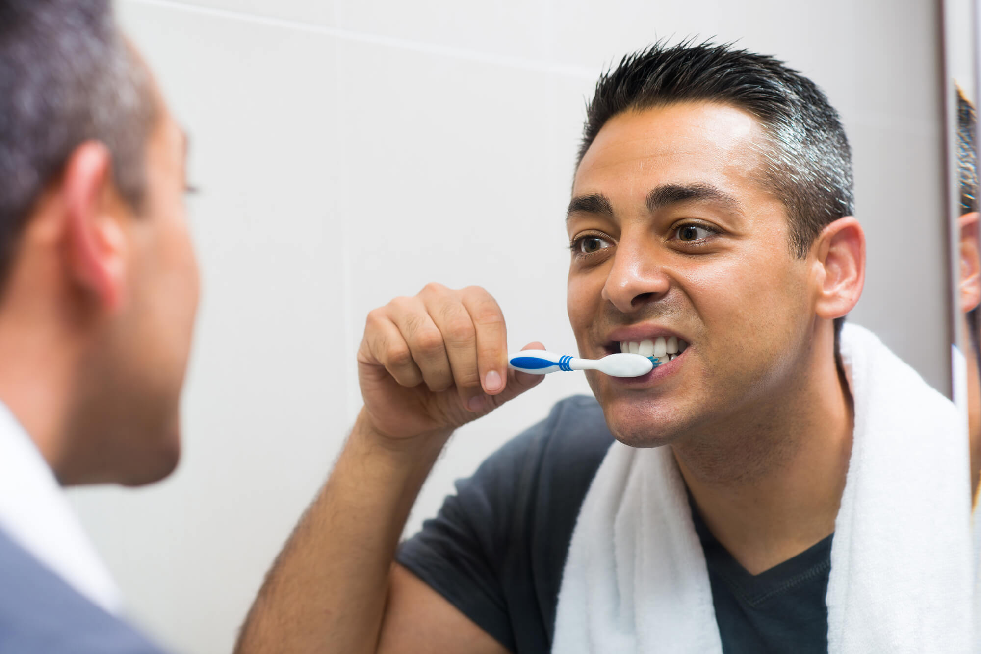 cosmetic dentists in Pompano Beach brushes his teeth