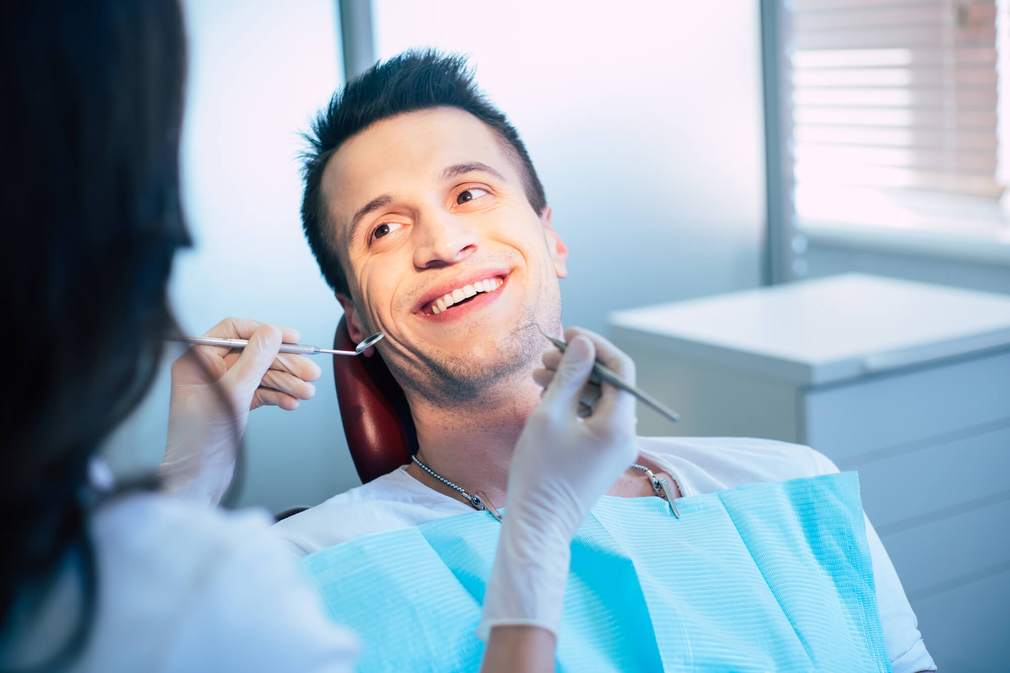 patient getting an examination before getting dental implants in 33062