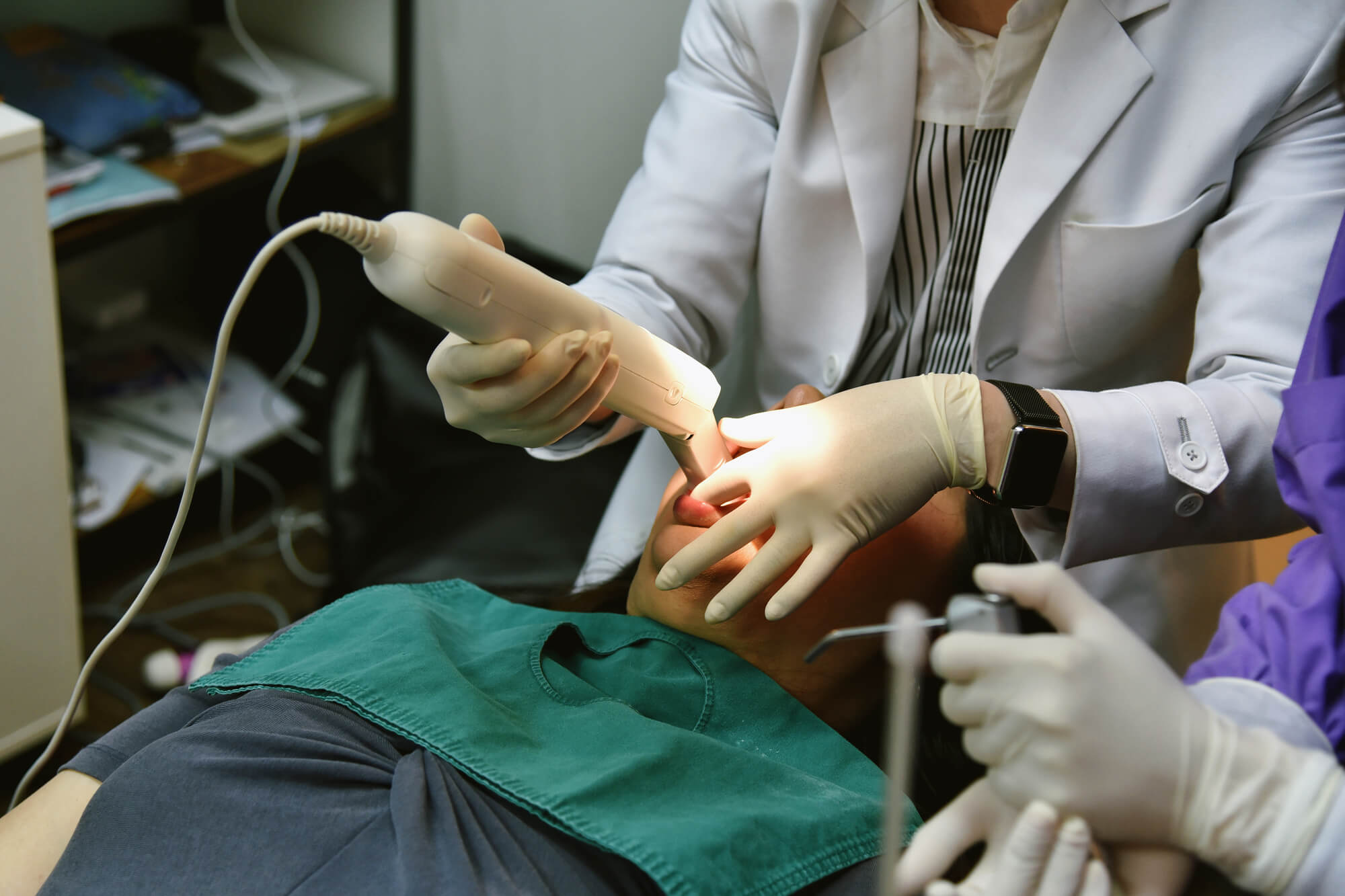 Periodontist in Pompano Beach cleaning patient's teeth