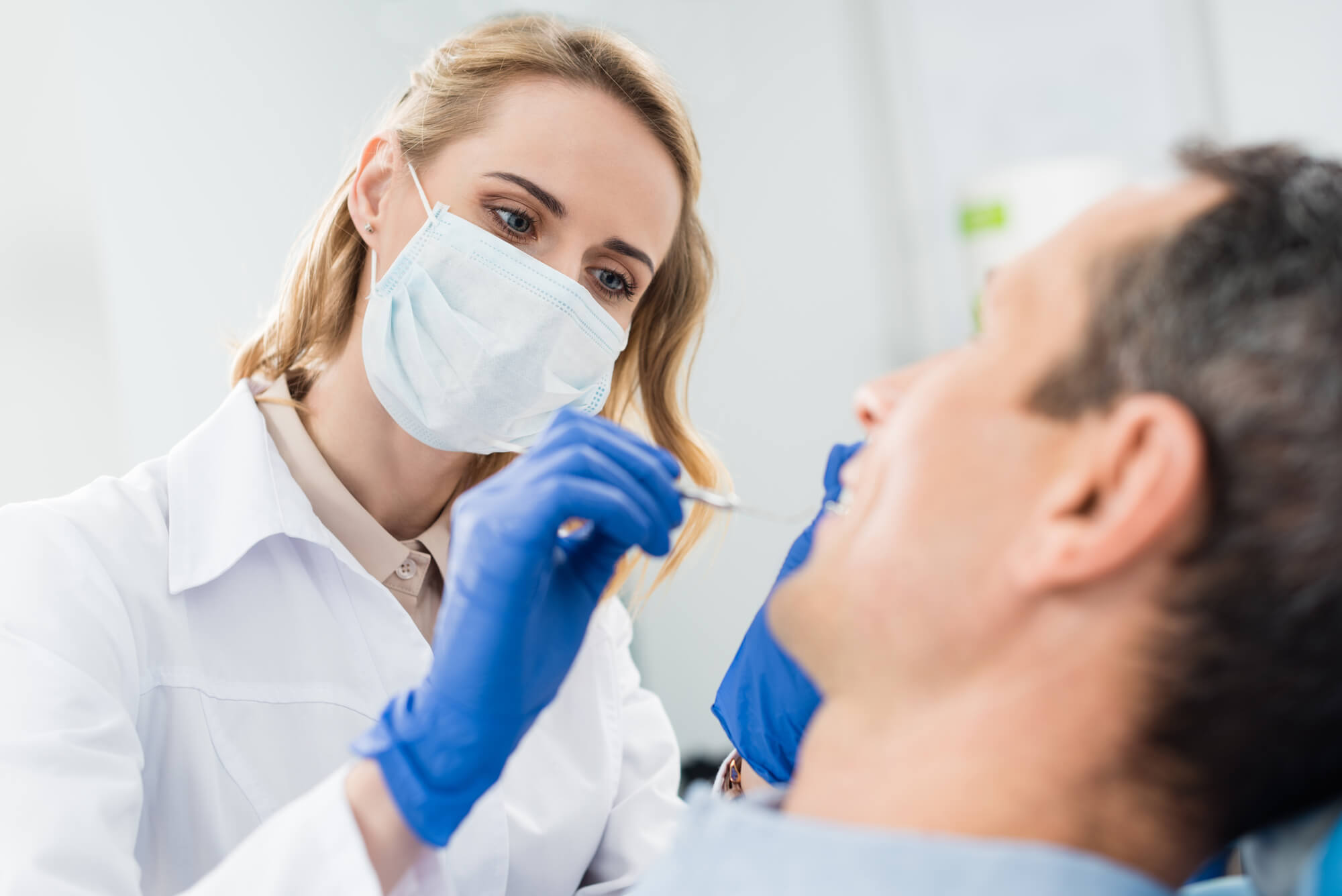 A Dentist in 33062 checking on a patient