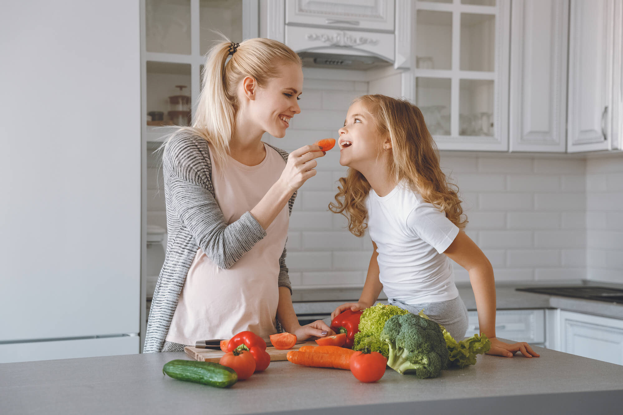 a woman and her child eating healthy food as advised by a Dentist in Pompano Beach