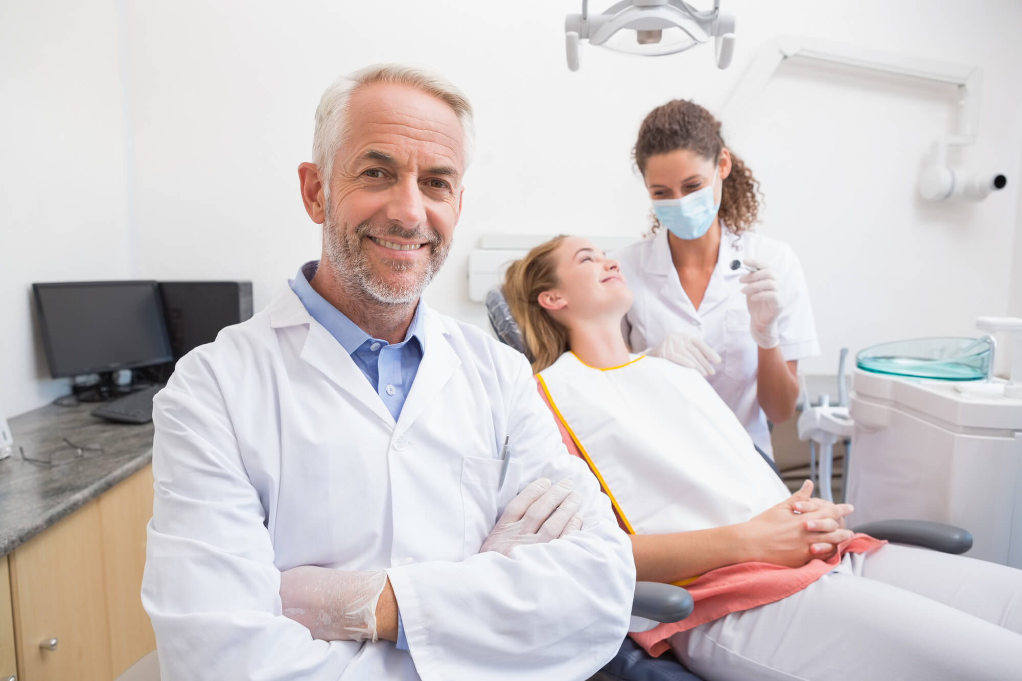 doctor smiles while patient is on dental chair after Sedation Dentistry in Pompano Beach