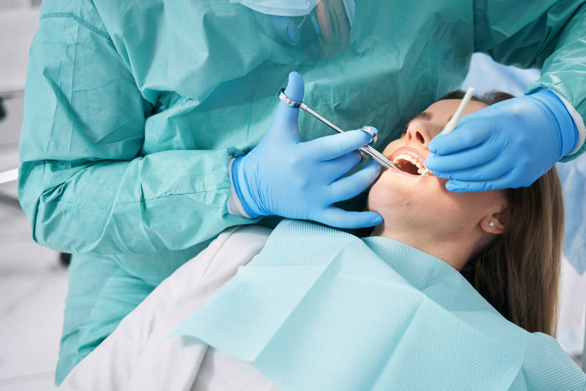 dentist during dental procedure after administering Sedation Dentistry Pompano Beach